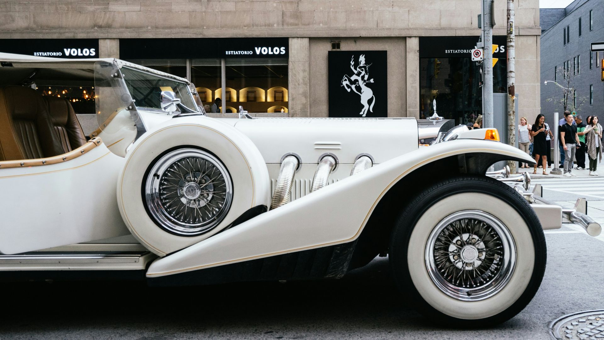 photo of classic white vehicle near pedestrian lane