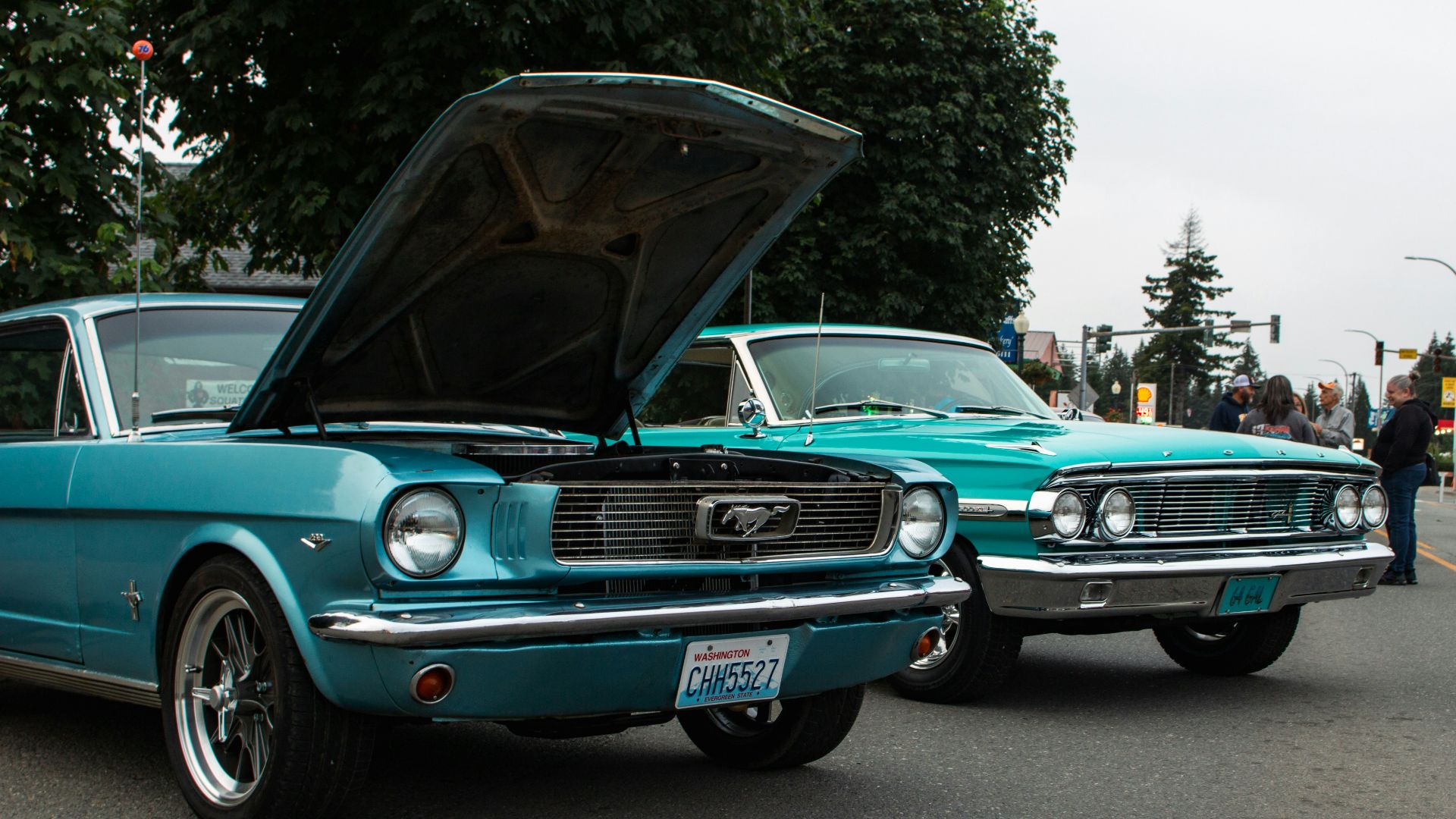 A couple of cars that are sitting in the street