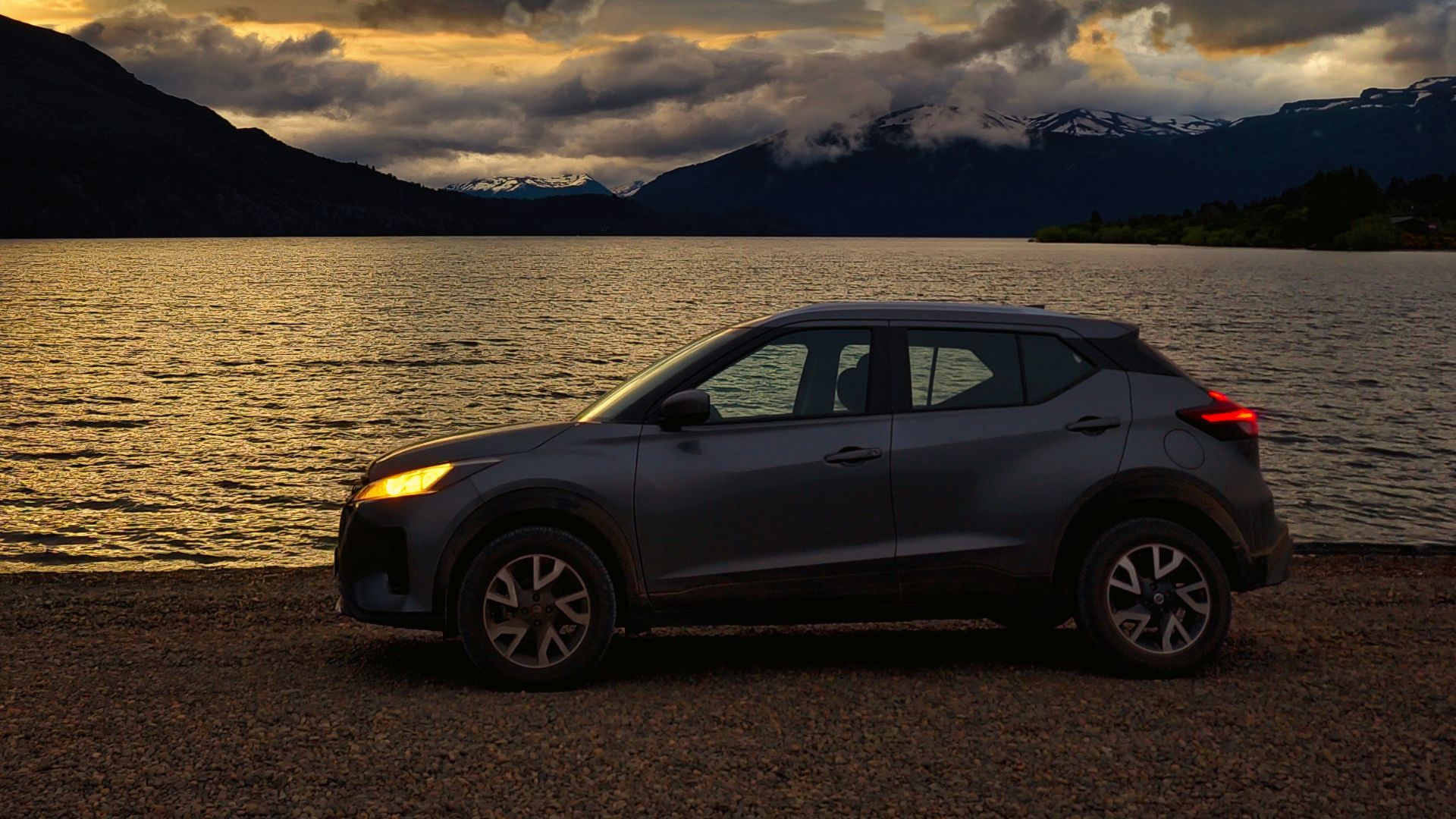 a car parked on the shore of a lake