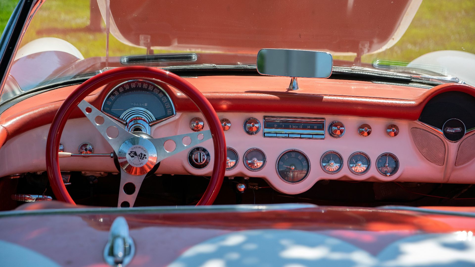 the dashboard of a classic car with a pink interior