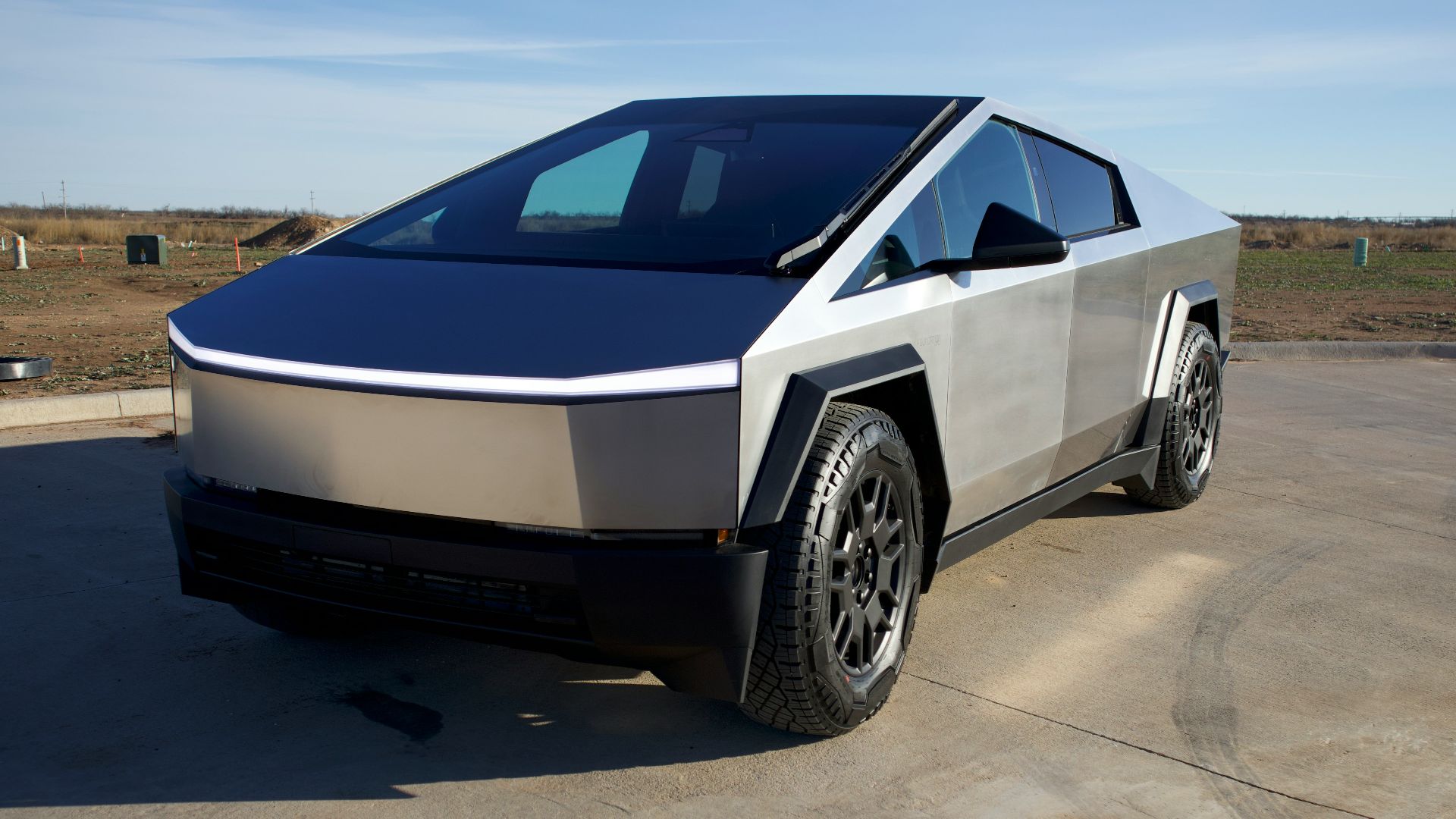 a silver and black car parked in a parking lot