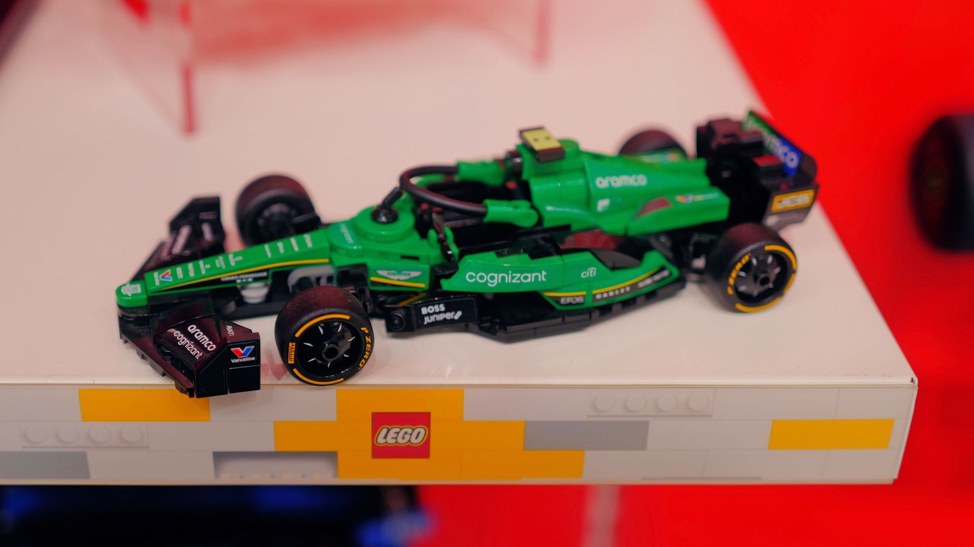 A green race car on display in a store