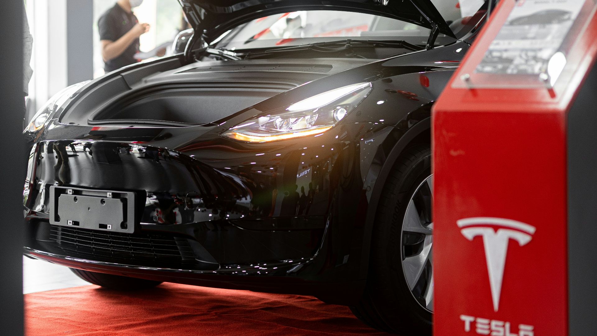 a tesla car is on display in a showroom