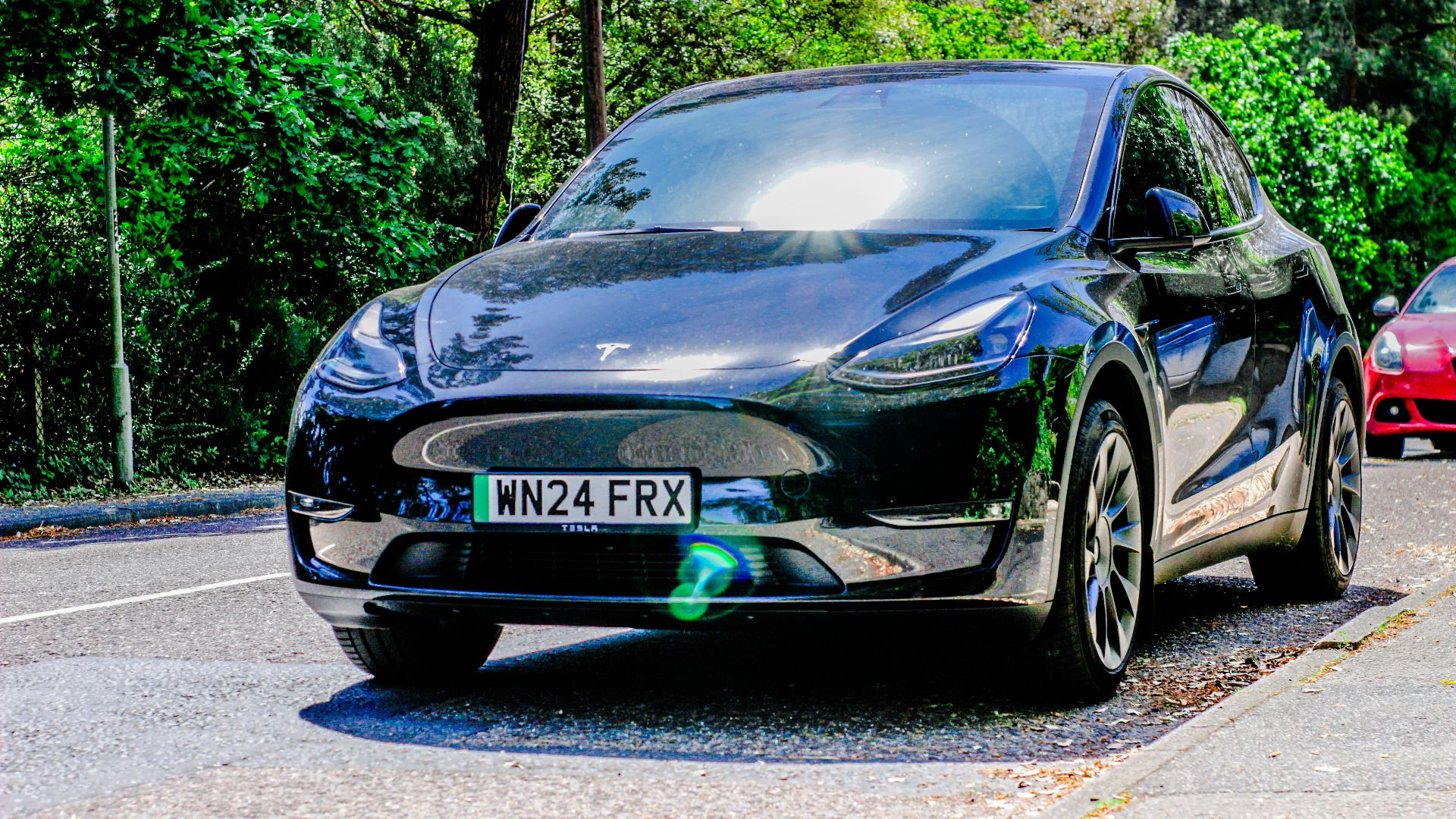 Two cars are parked on the side of the road