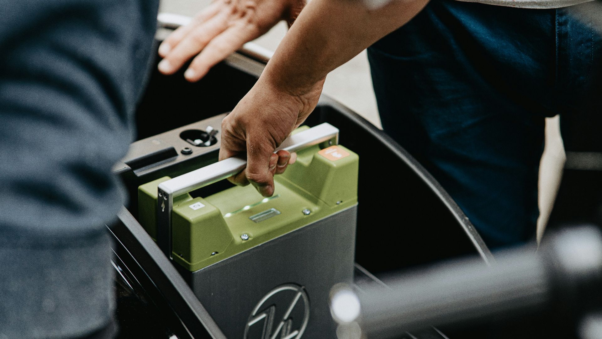 person holding black and green electronic device