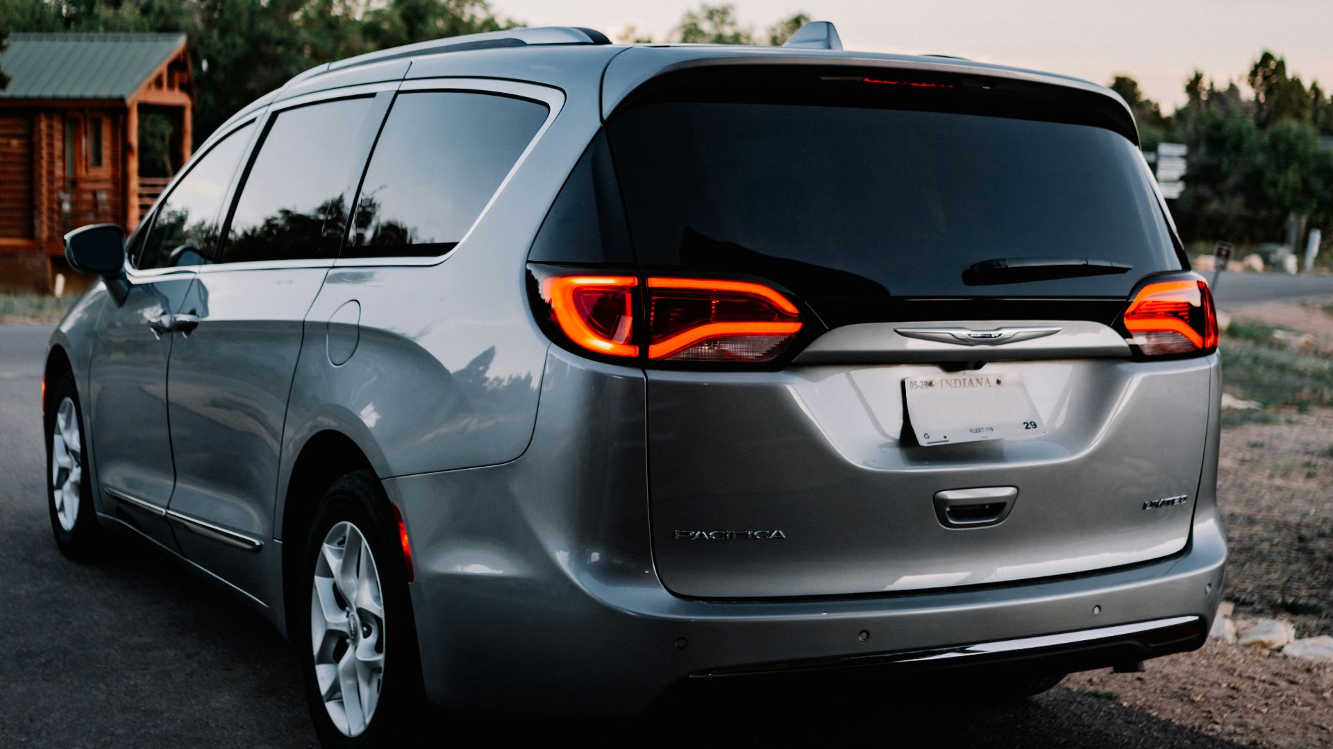 a silver minivan parked in a parking lot