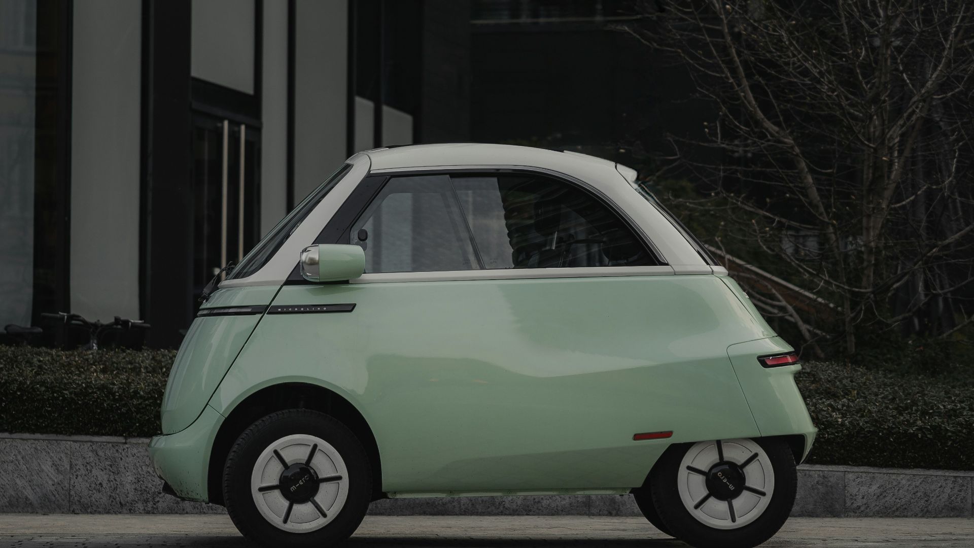 A small car is parked on the side of the road