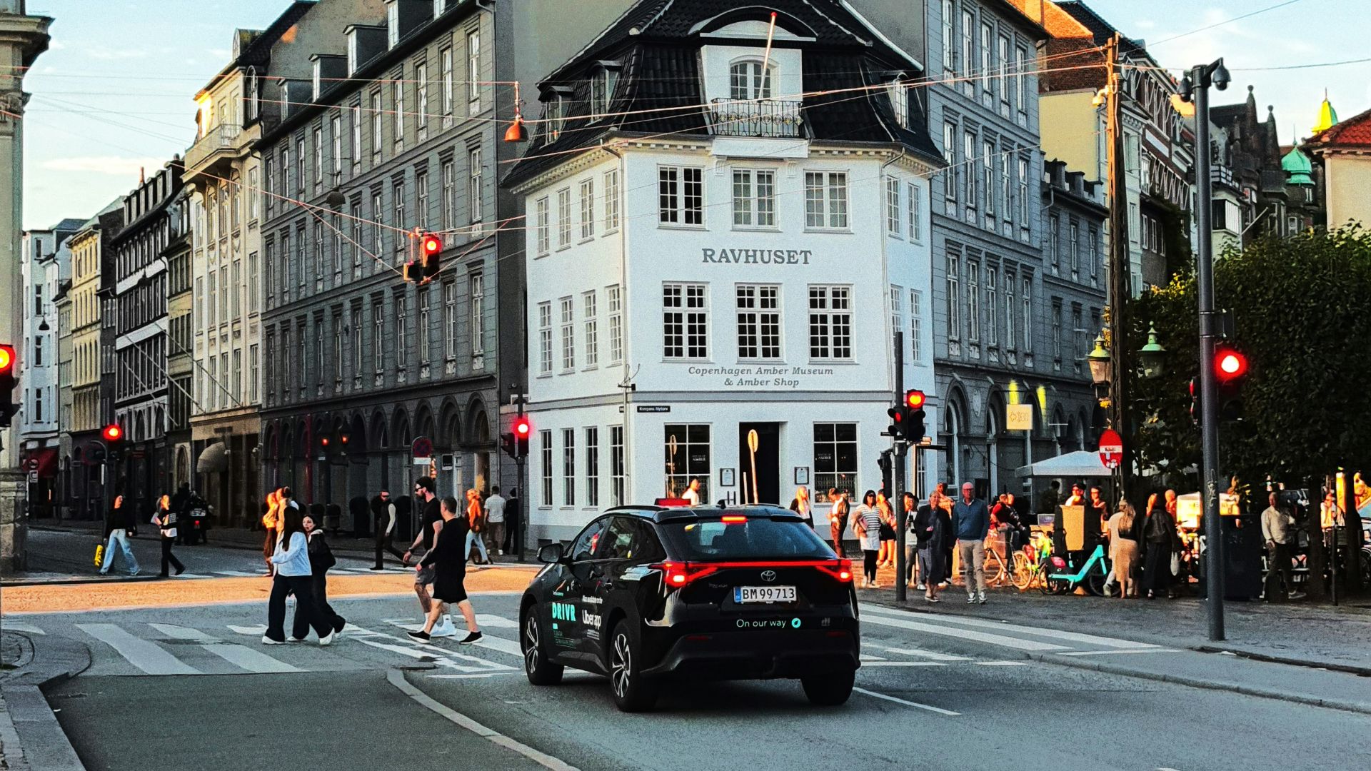 City street with pedestrians and cars at intersection.