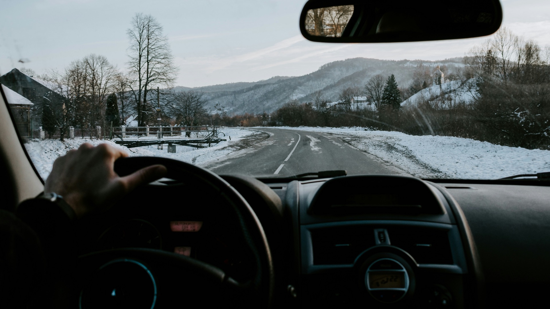 person holding steering wheel