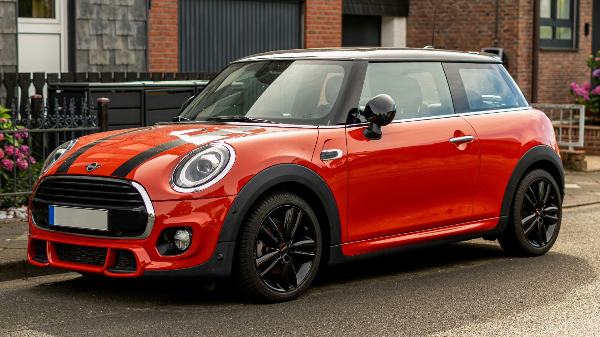 A red mini cooper parked on the side of the road