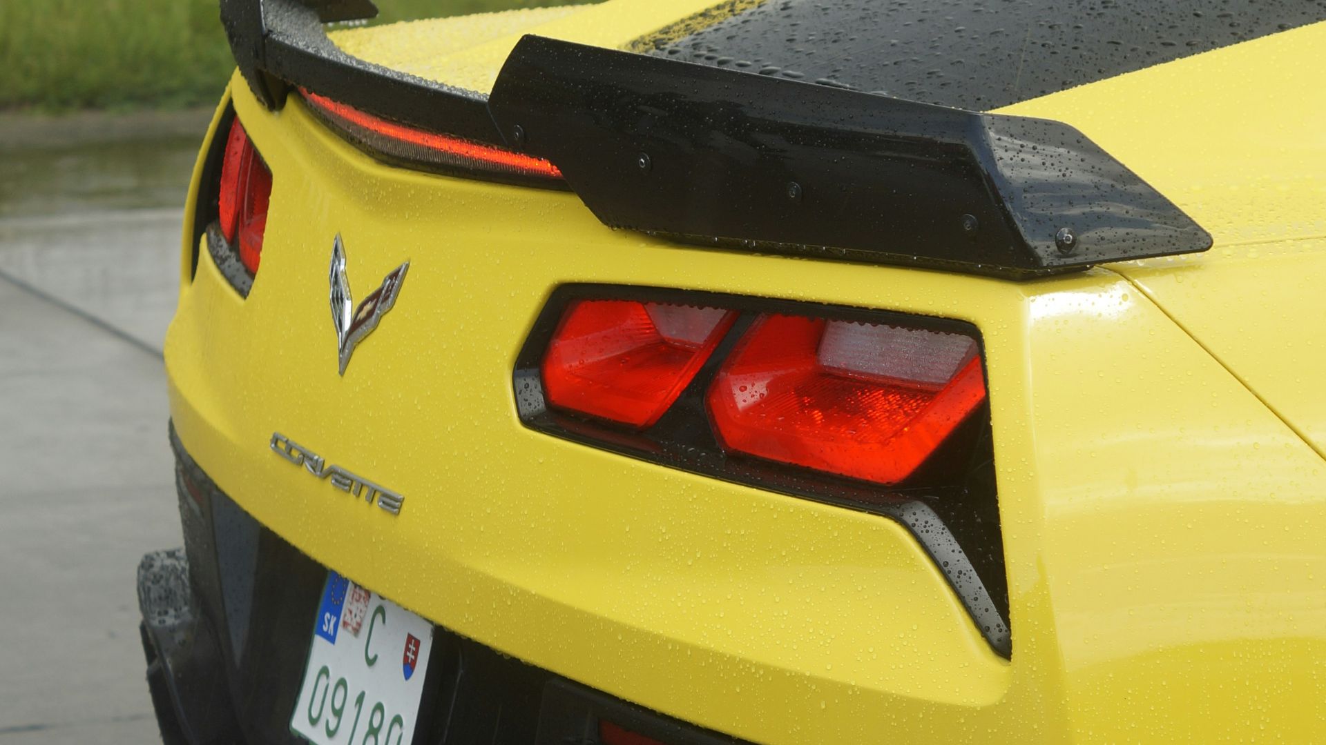 A yellow sports car parked in a parking lot