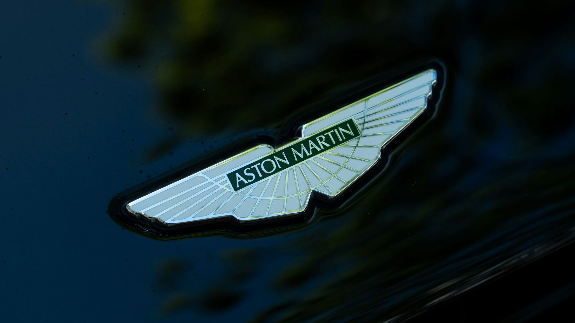 Aston martin's winged emblem is displayed on the car.