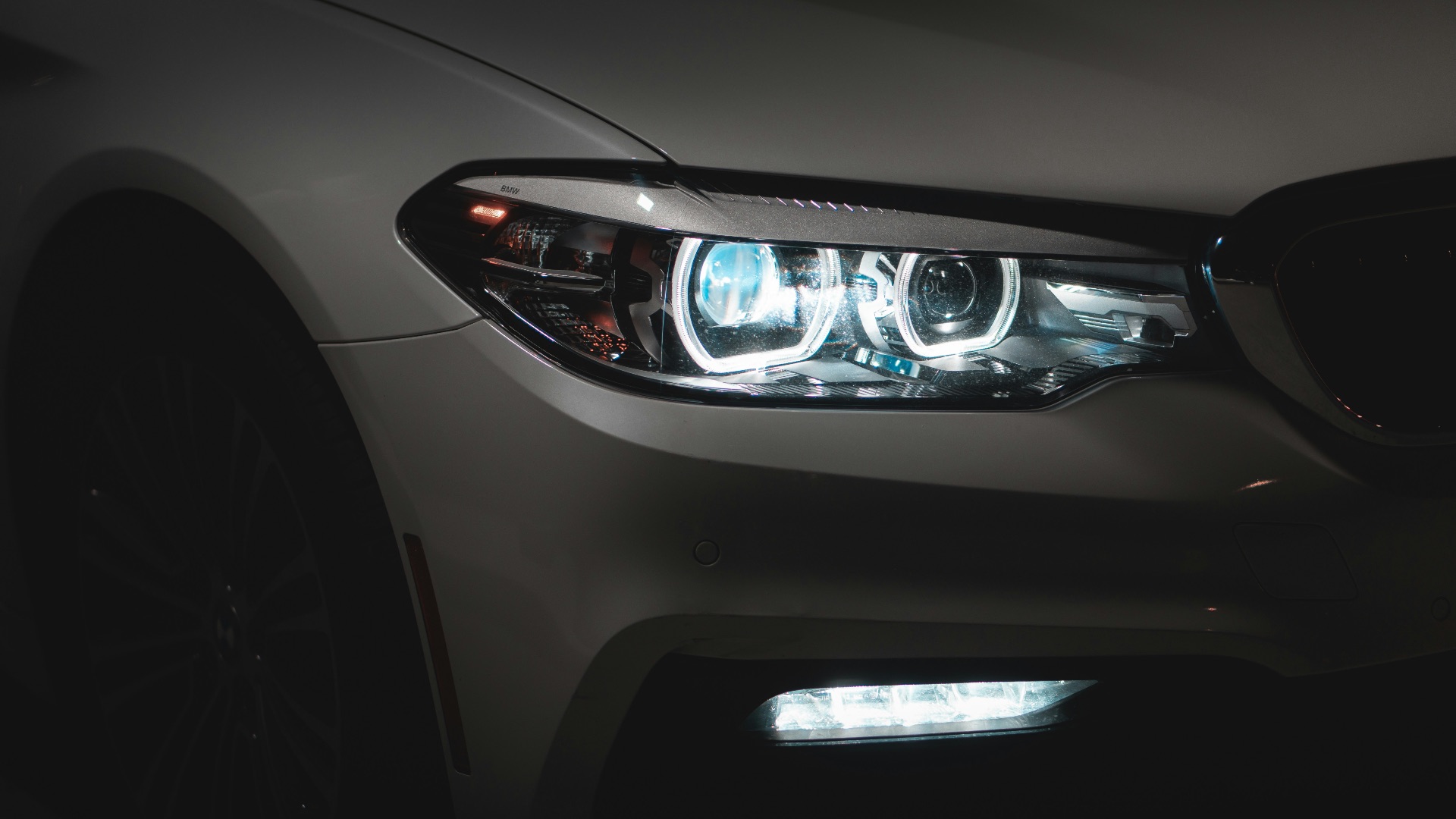 gray car with white and blue lights