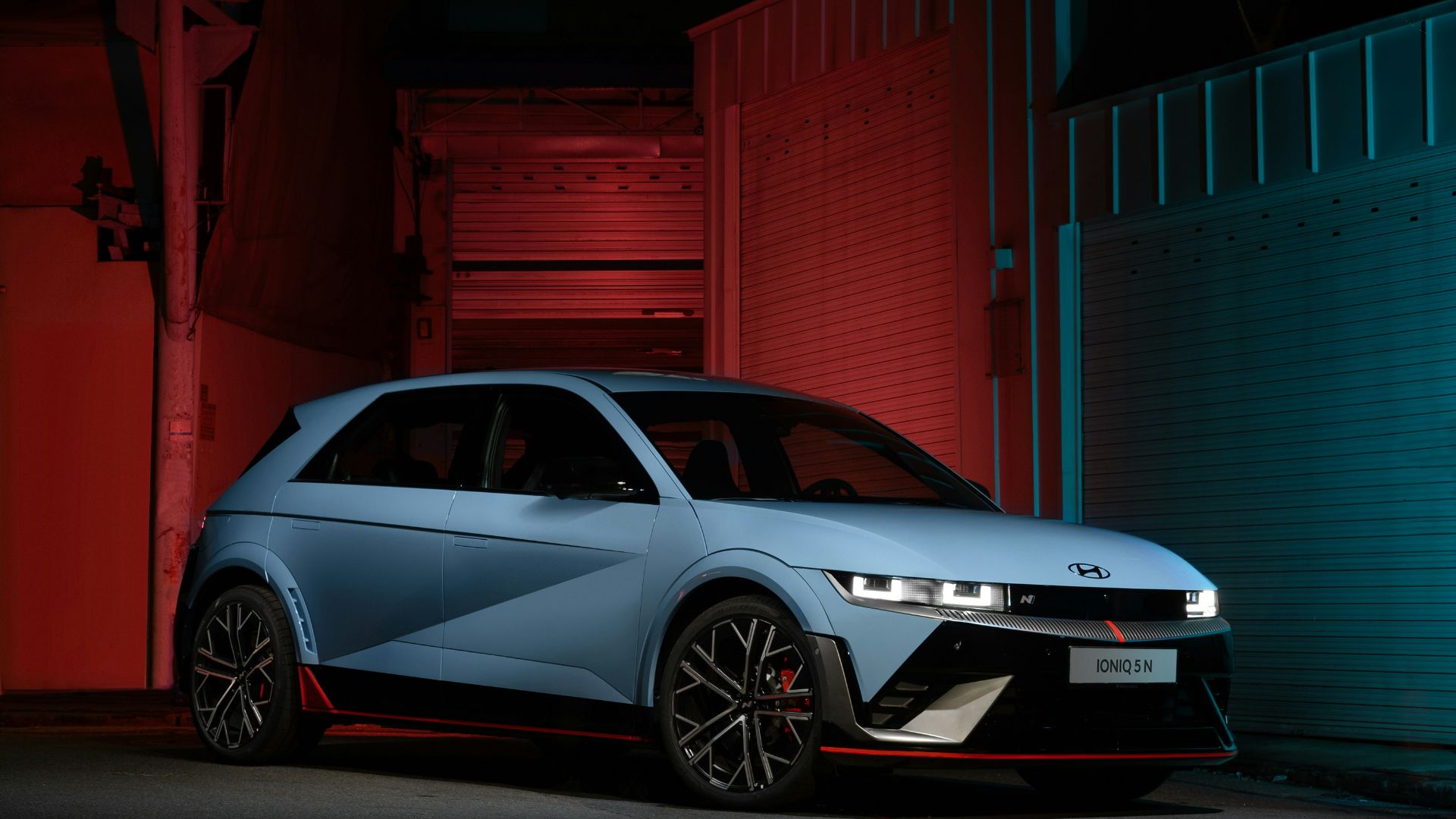 a blue car parked in front of a building