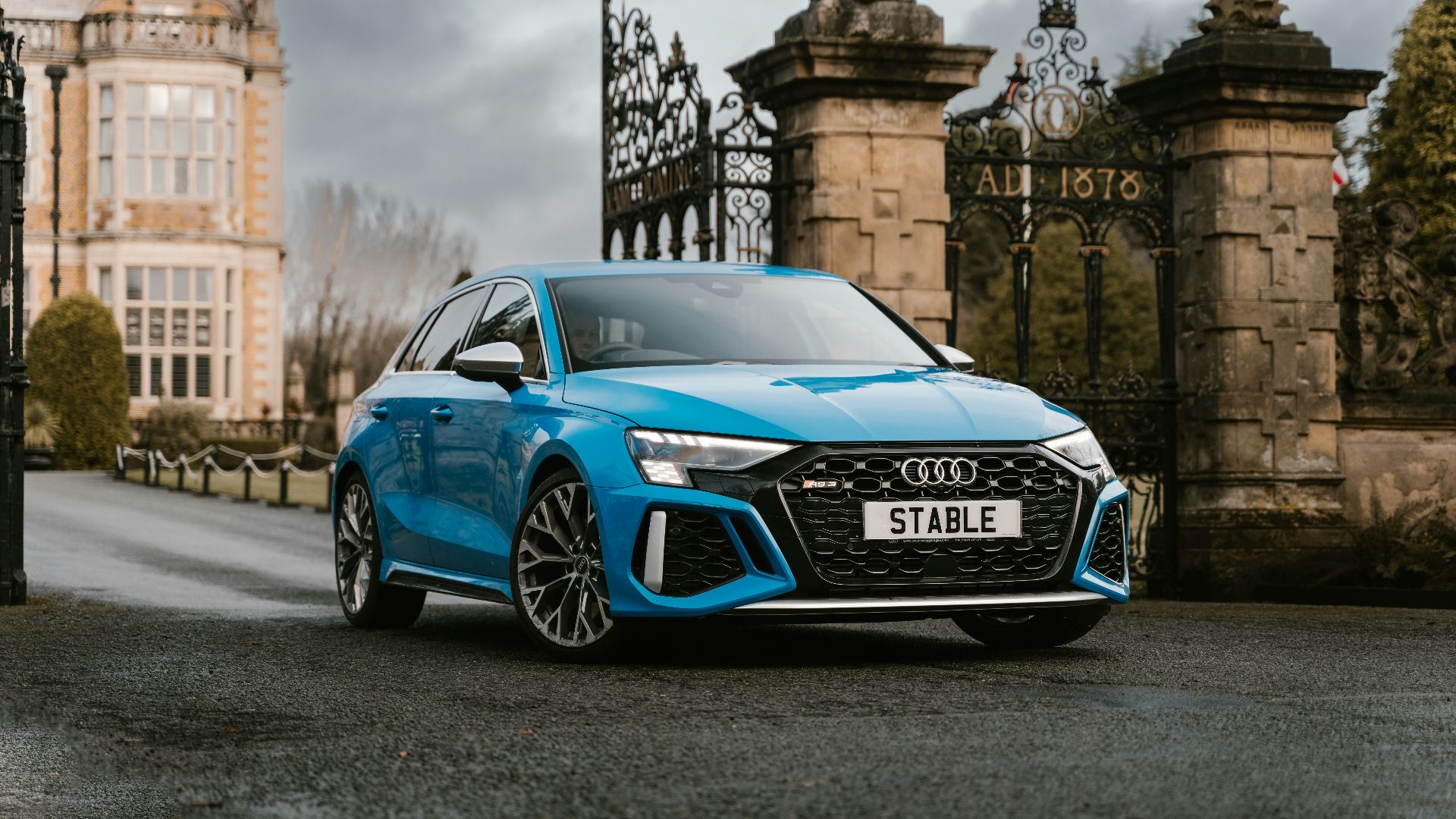 a blue car parked on a street