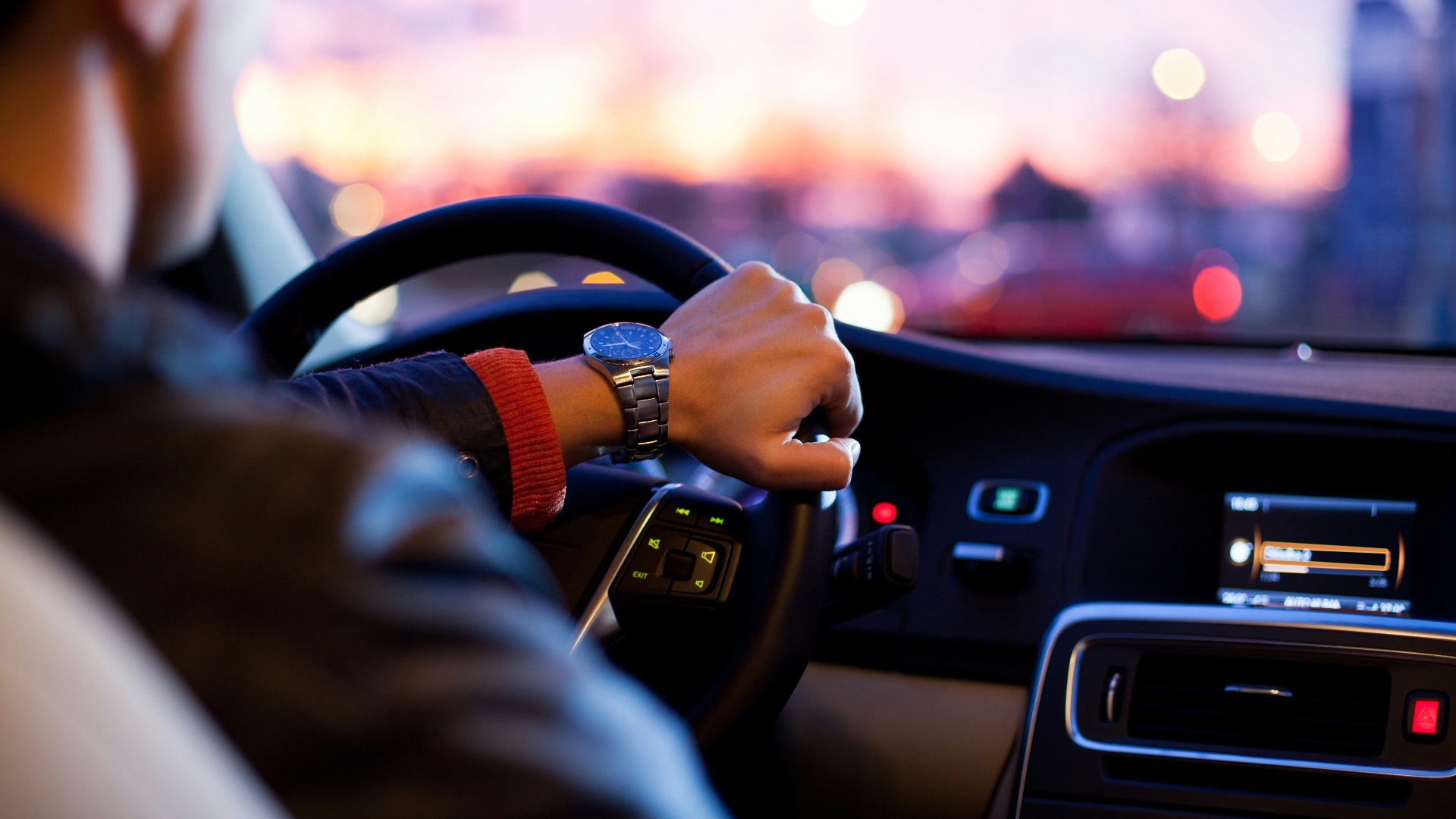 man driving a car wearing wrist watch