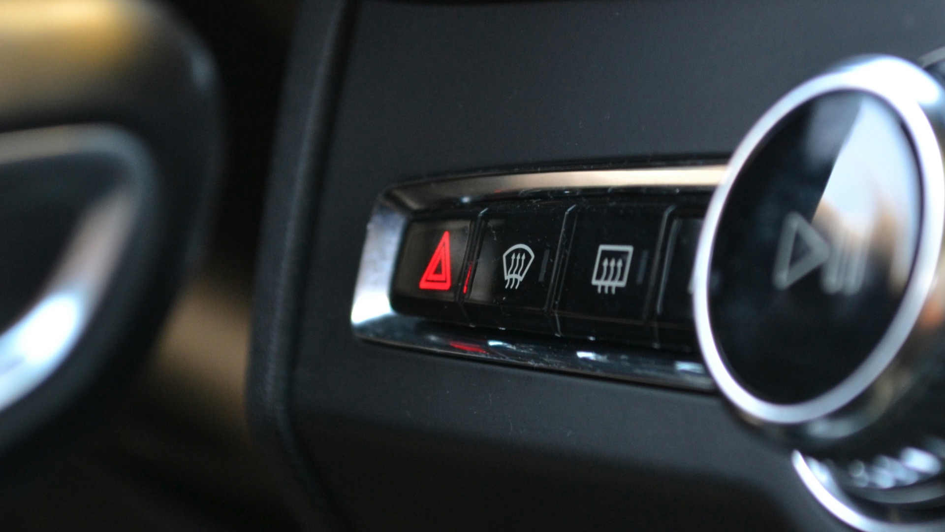 Car's interior controls, including hazard lights.