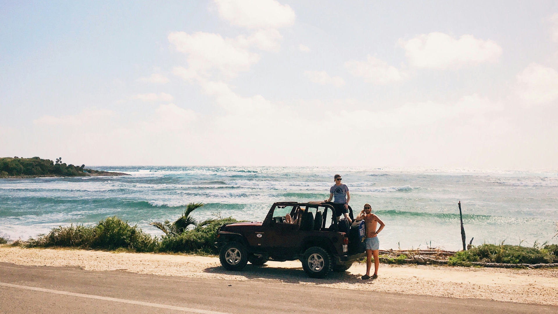 two men on brown SUV at daytime