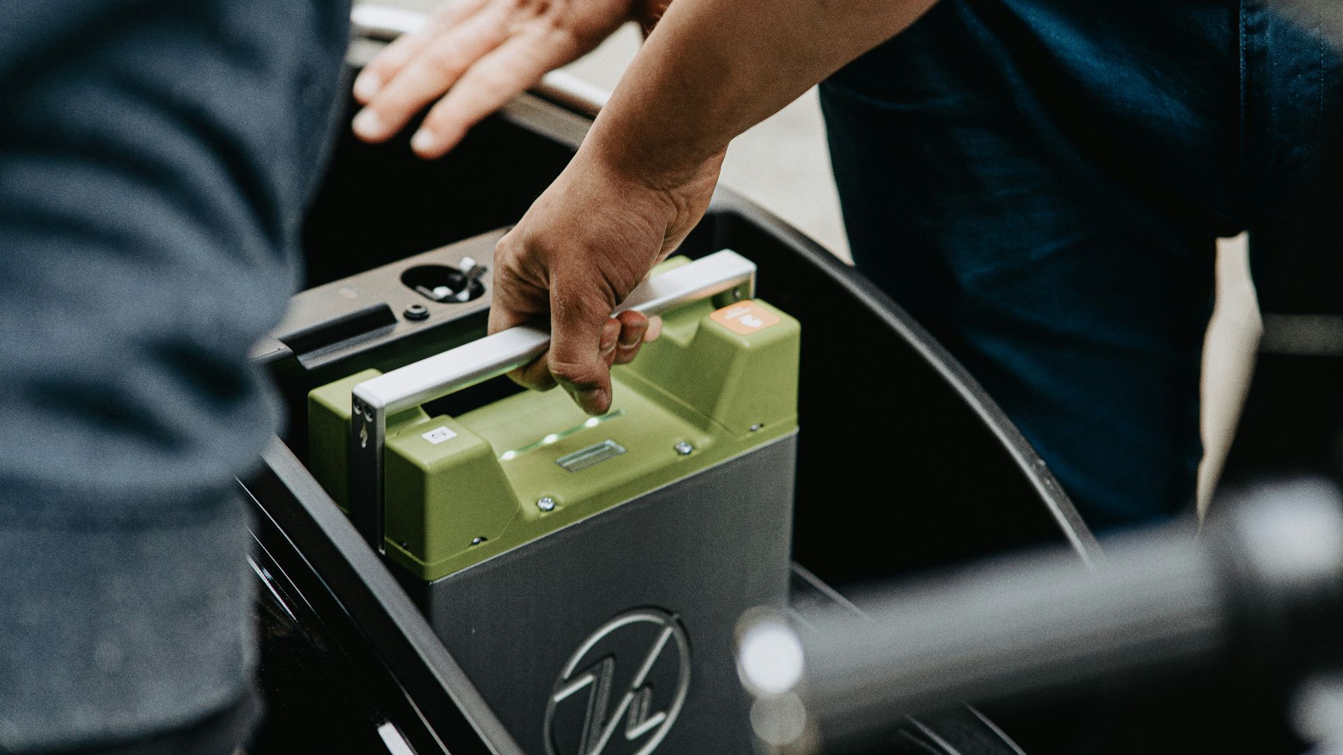 person holding black and green electronic device