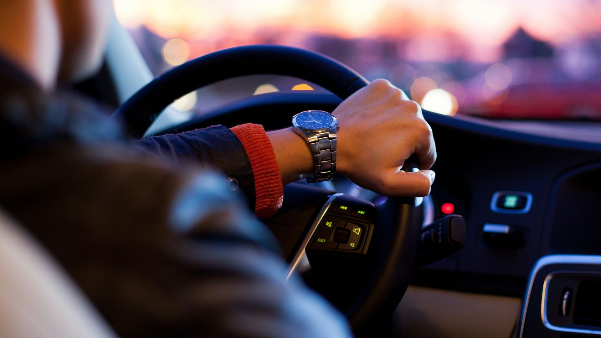 man driving a car wearing wrist watch