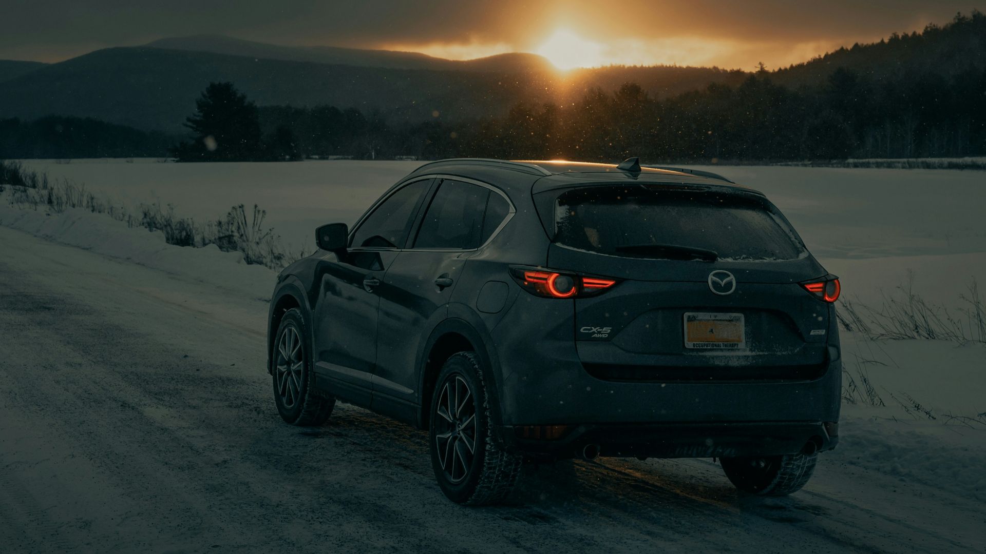 black bmw x 6 on snow covered field during daytime