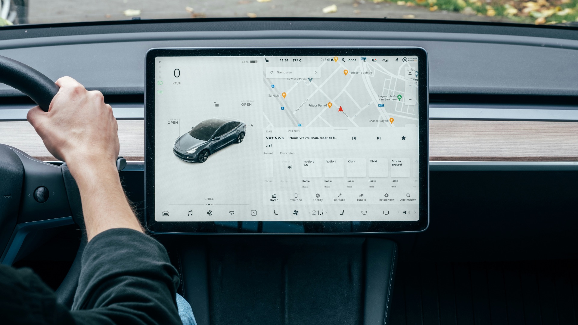 a person driving a car with a computer on the dashboard