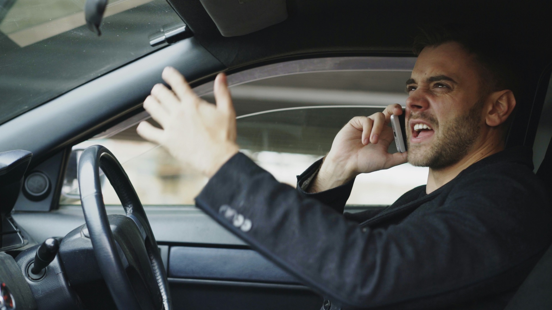 Man talking on phone while driving car