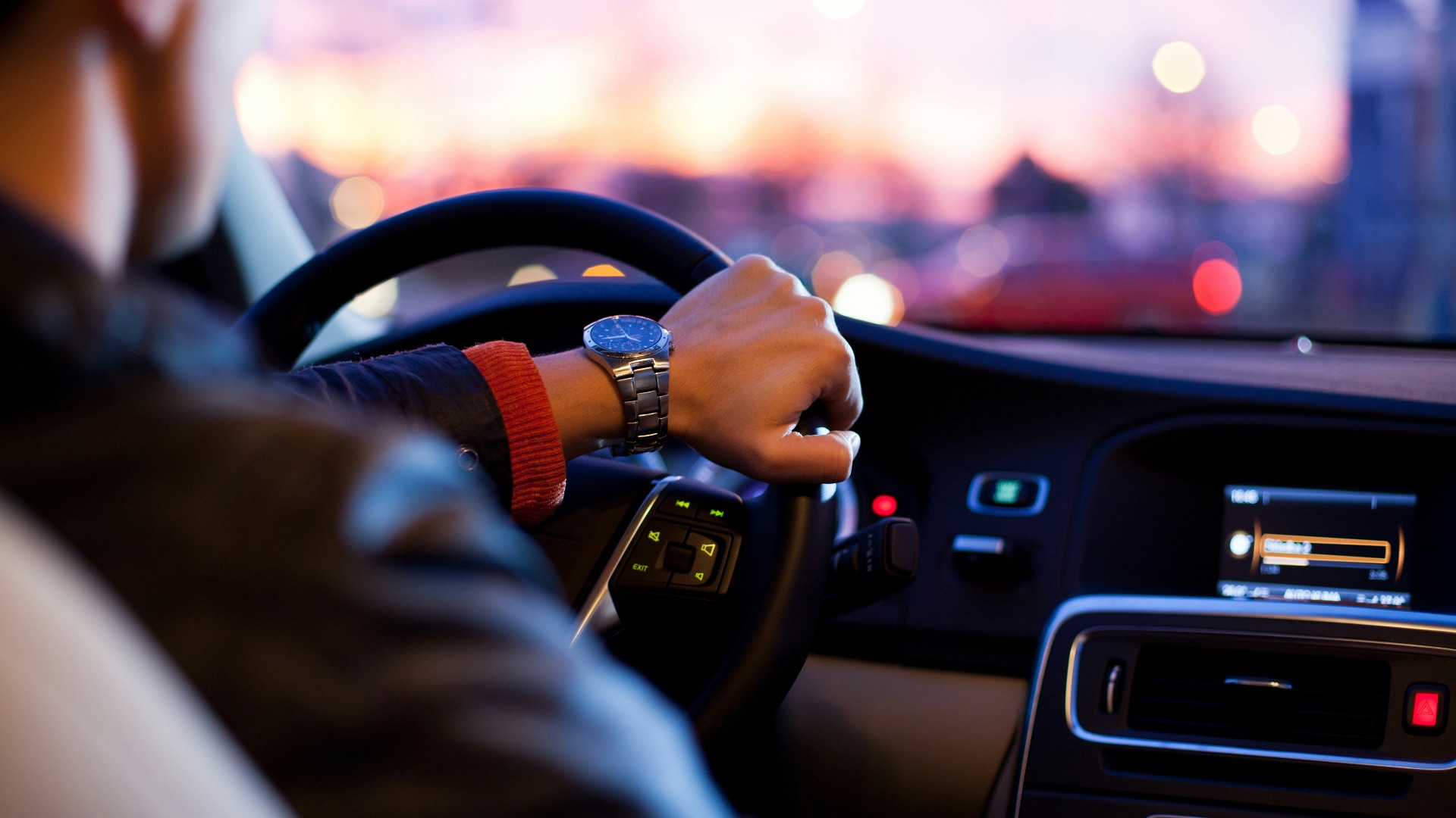 man driving a car wearing wrist watch