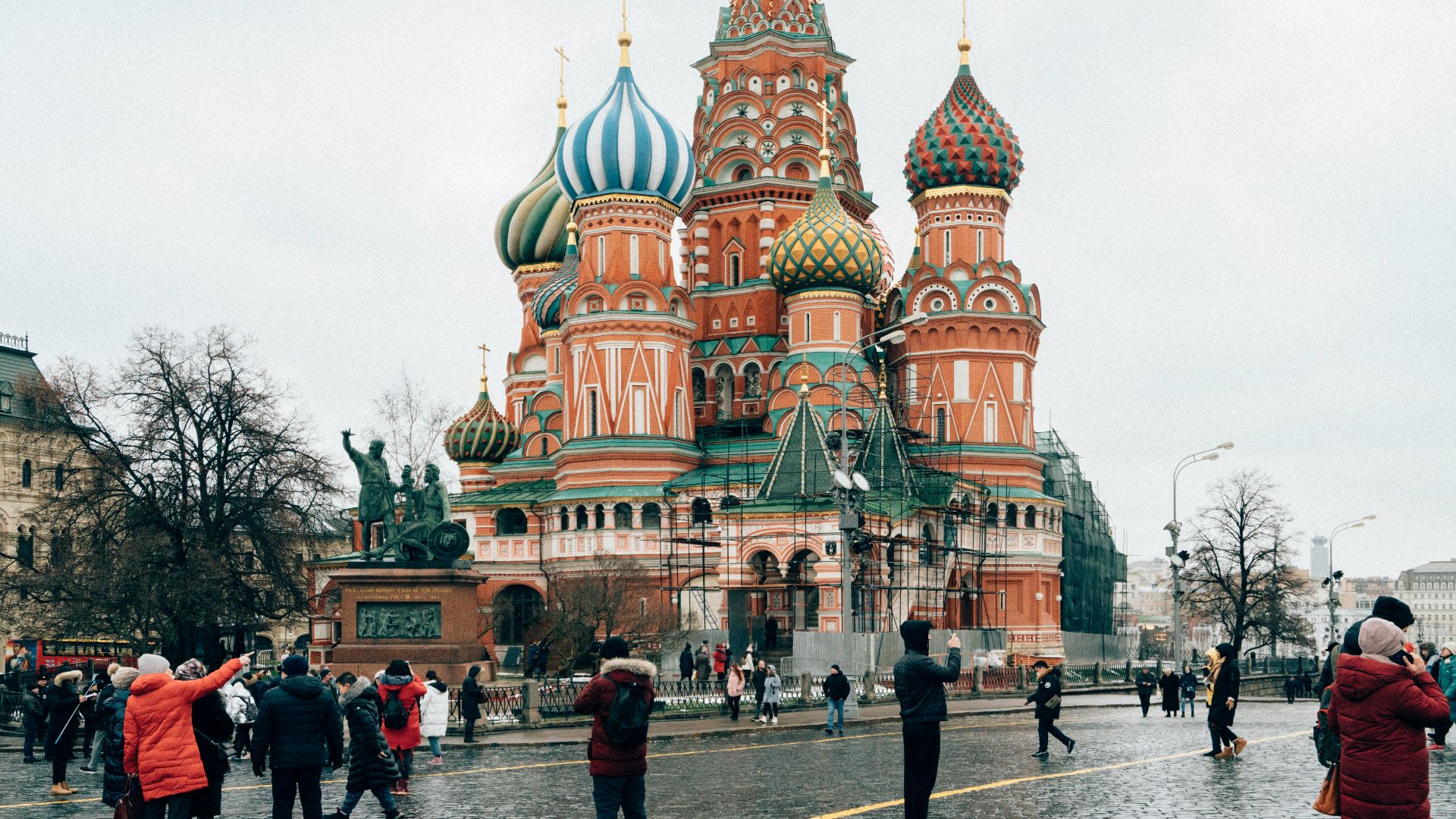 people walking on street near brown and green building during daytime