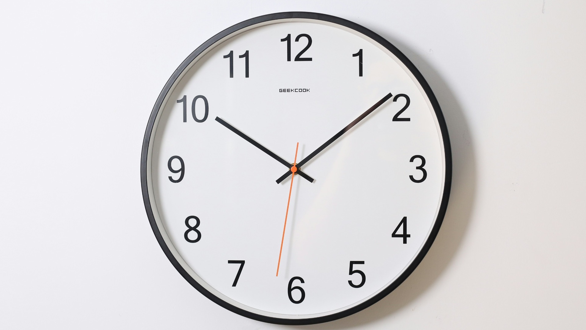 round analog wall clock pointing at 10:09