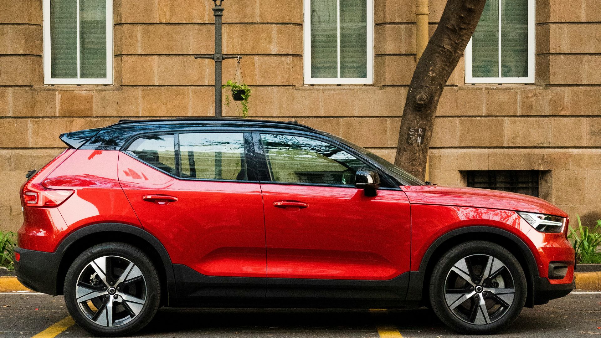 a red car parked in front of a building