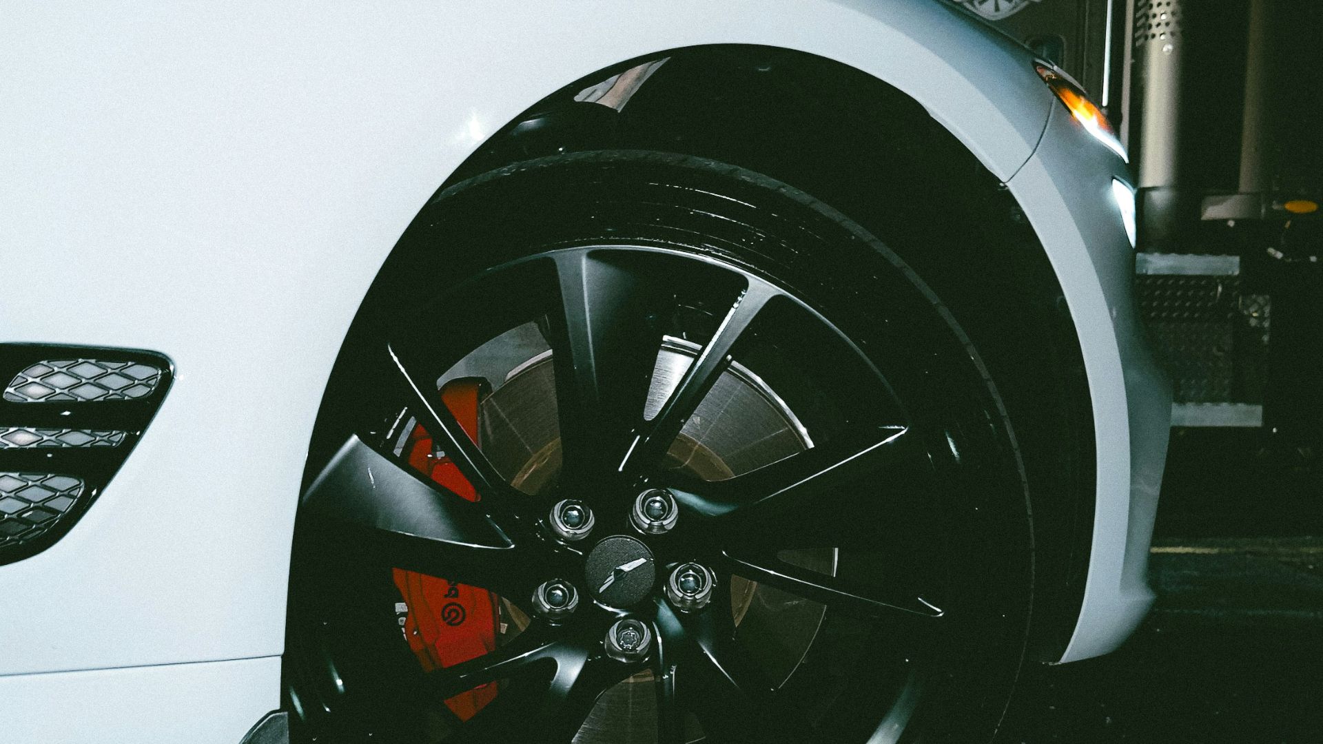 a close up of a tire on a white car