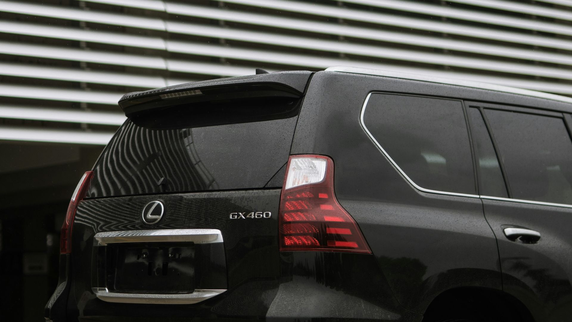 a black suv parked in front of a building