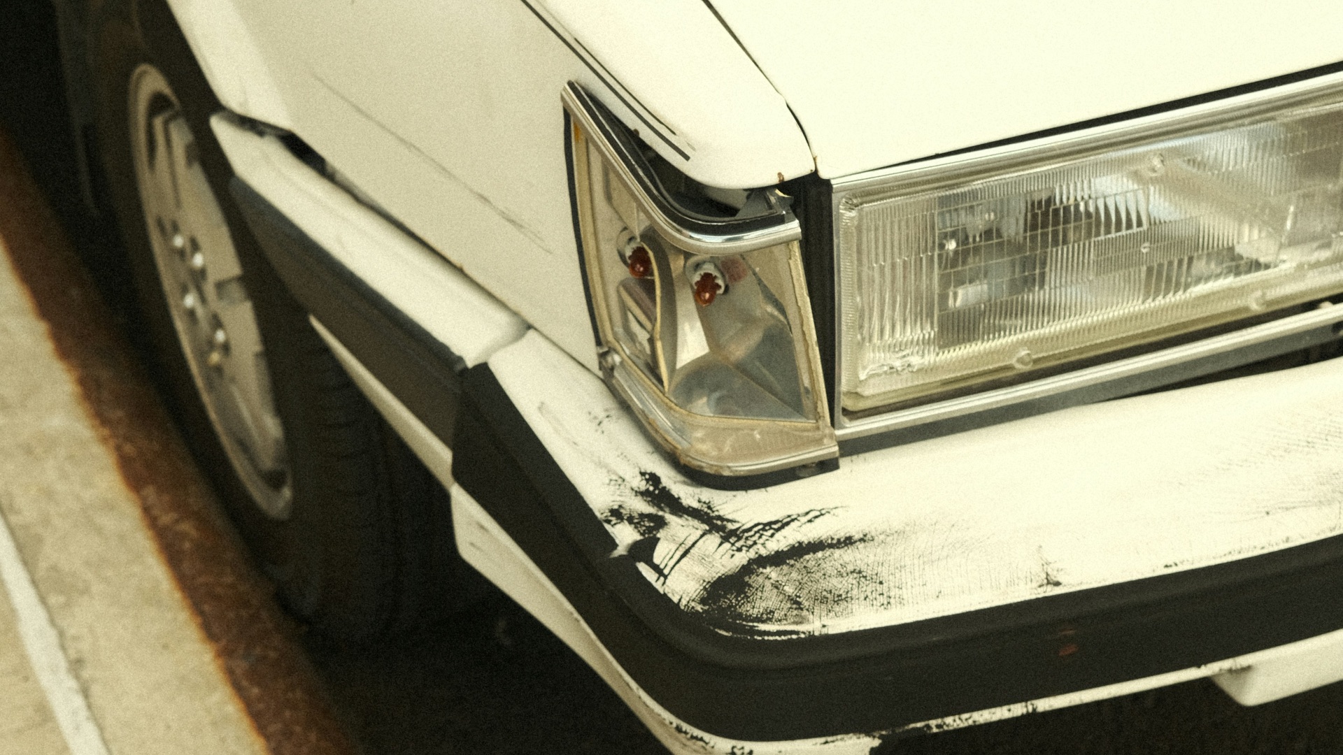 A white car parked on the side of the road