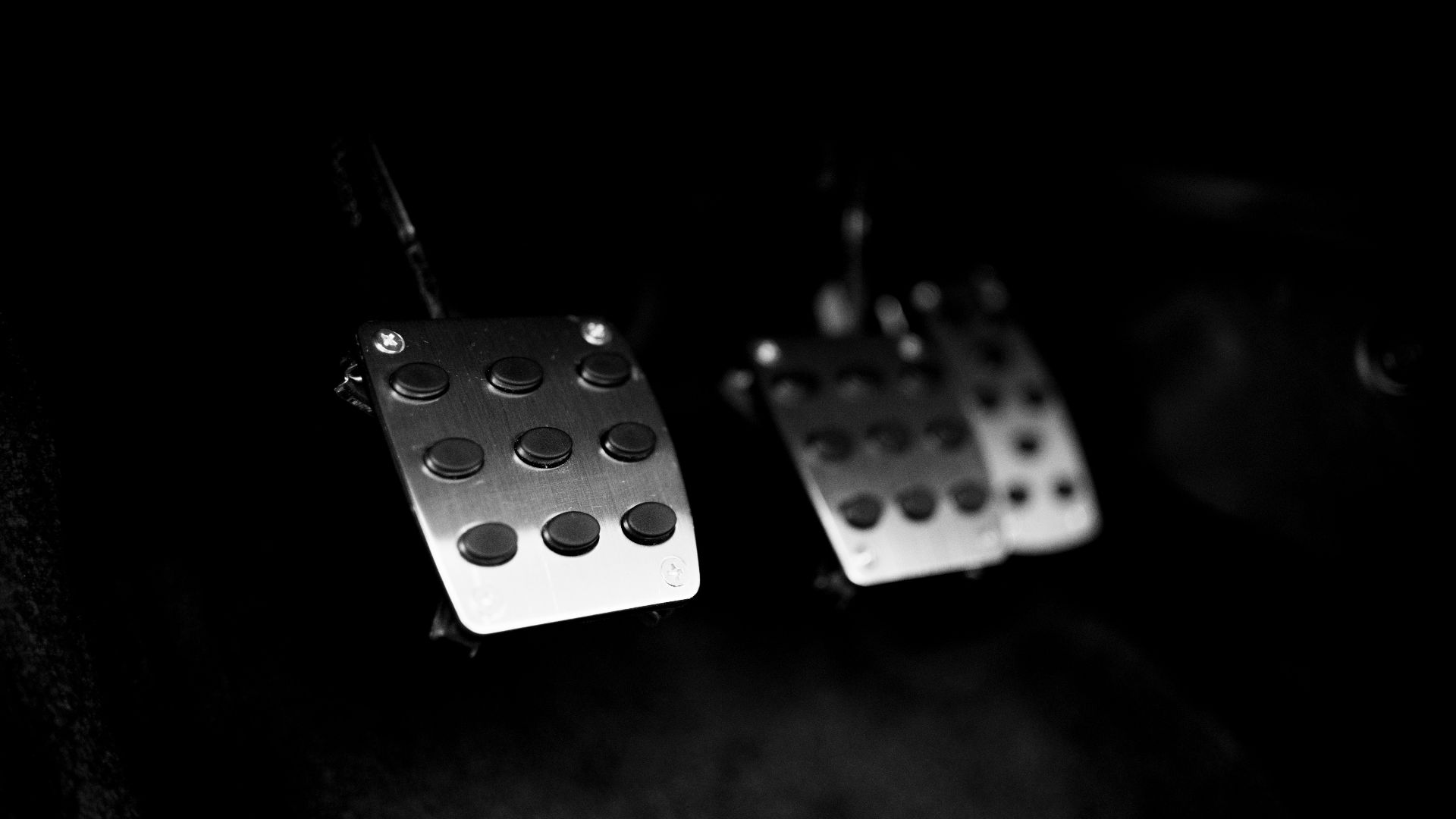 a pair of dice earrings hanging from a hook