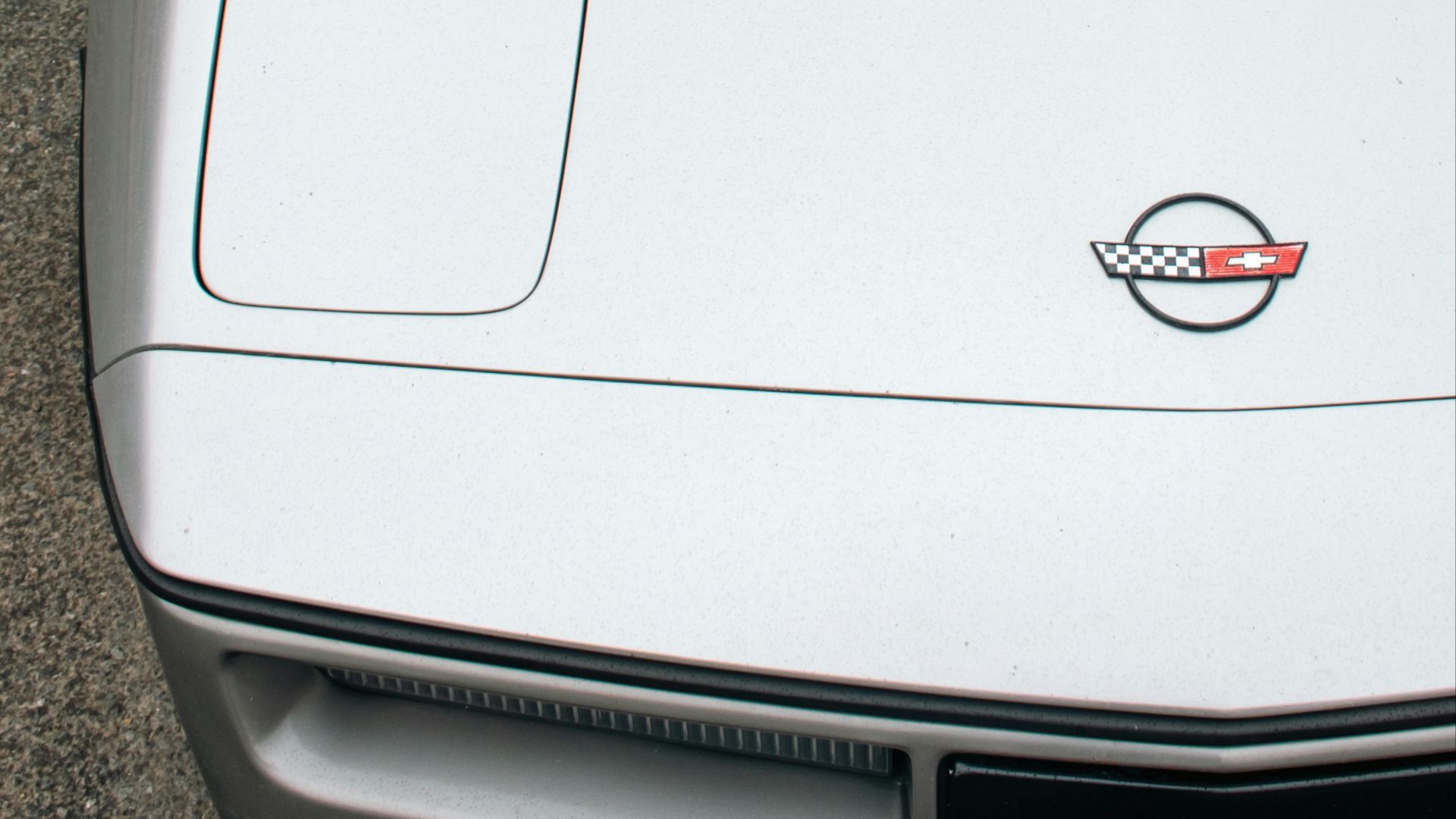 A white sports car parked in a parking lot