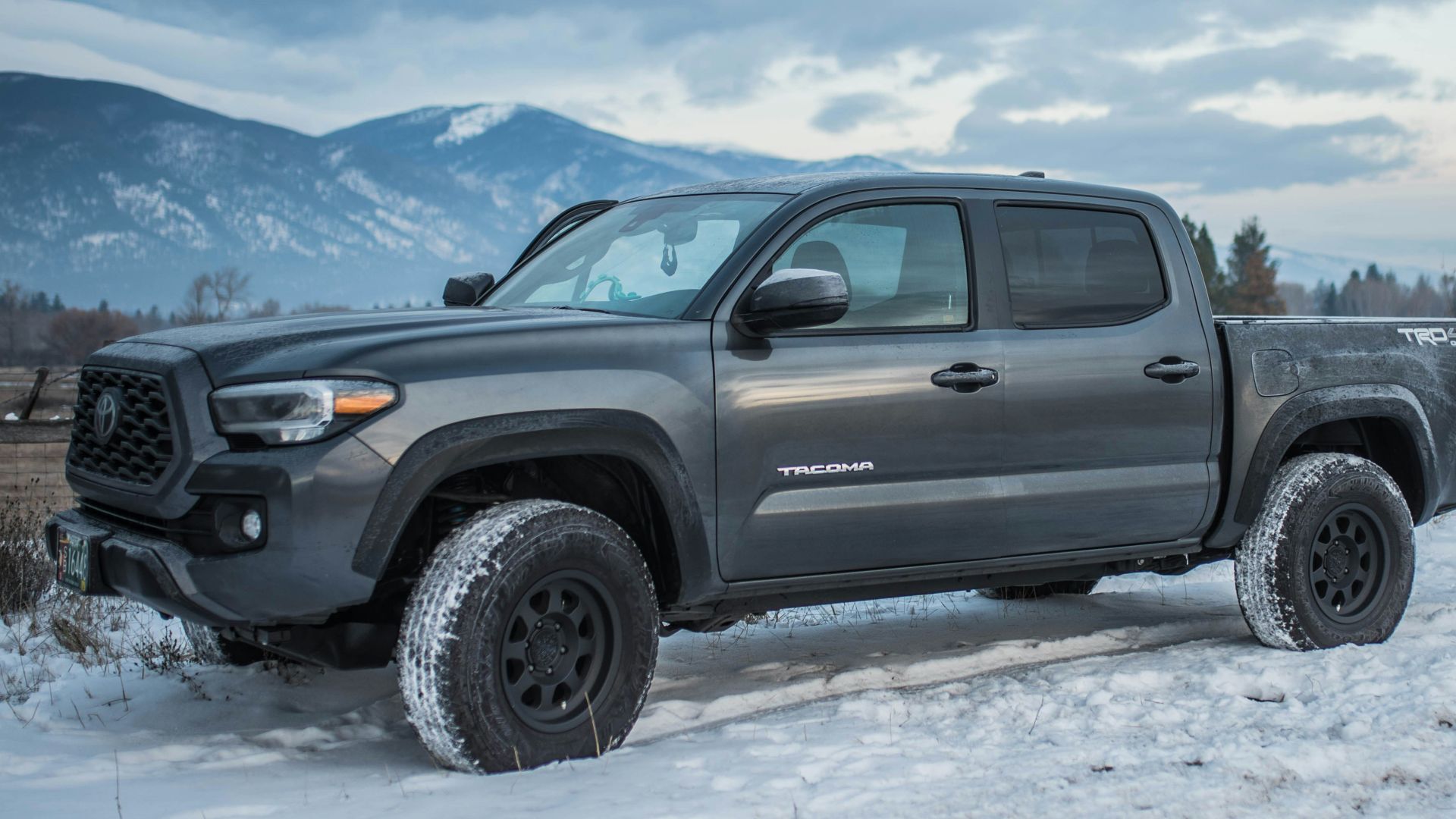 gray chevrolet crew cab pickup truck on snow covered ground during daytime
