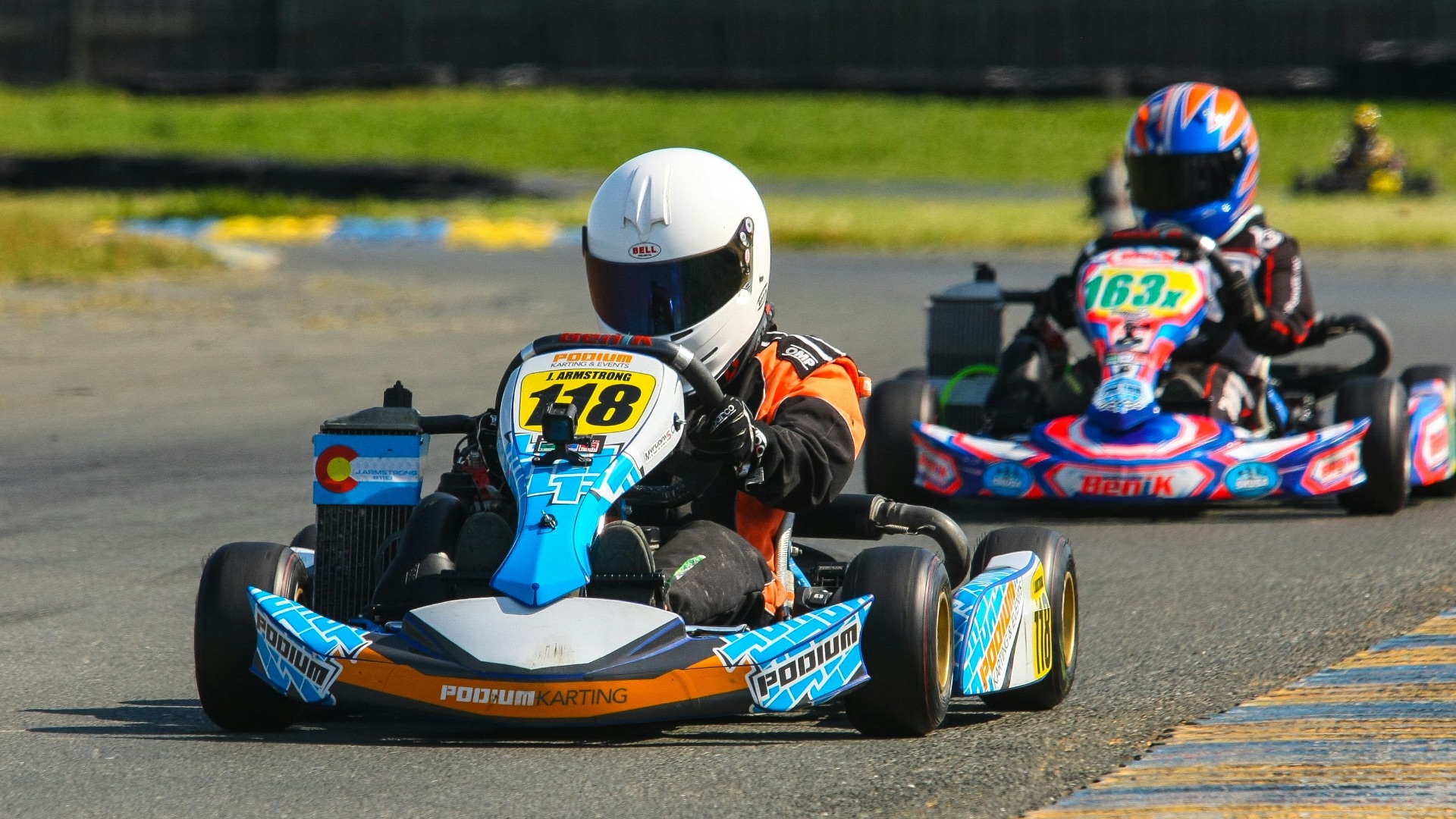 two go kart drivers on race track