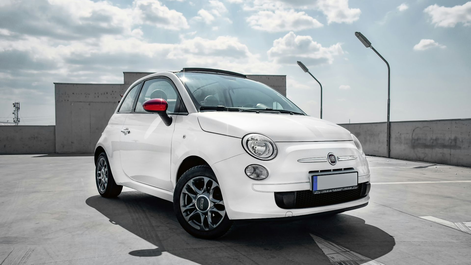 white 3-door hatchback on gray floor