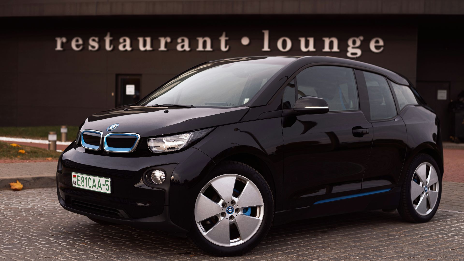 a black car parked outside a building
