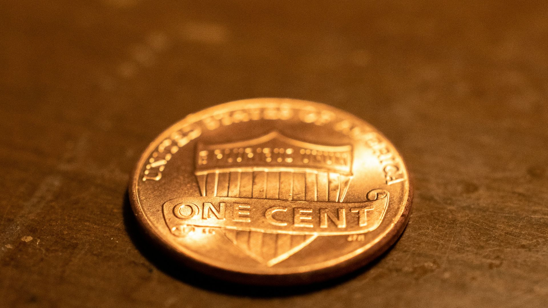 a penny sitting on top of a wooden table