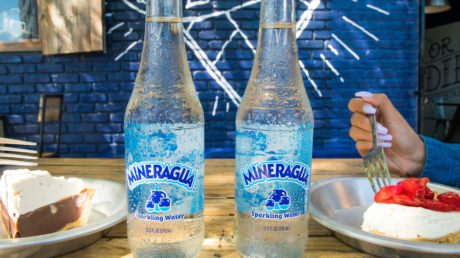 2 blue and white glass bottles on brown wooden table