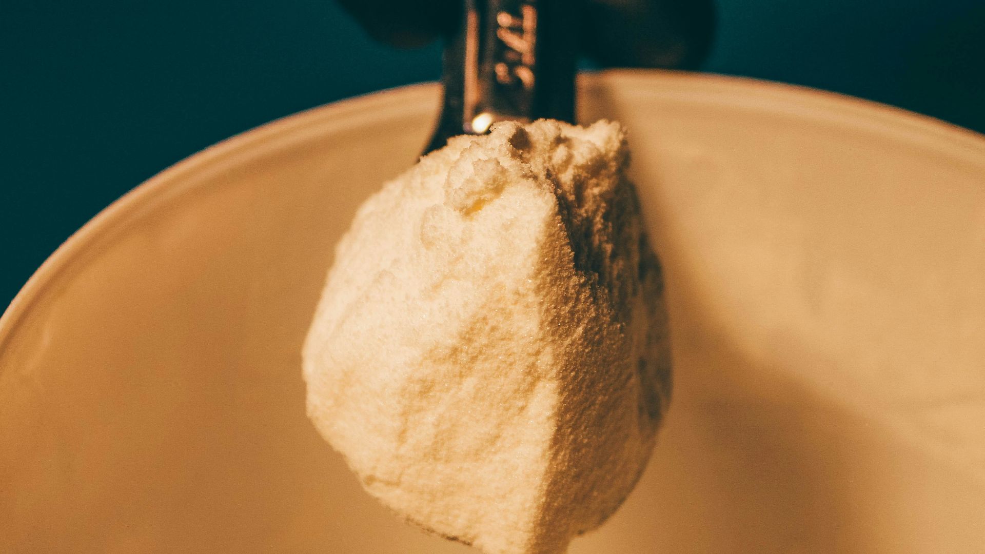 a person is holding a spoon with some food in it