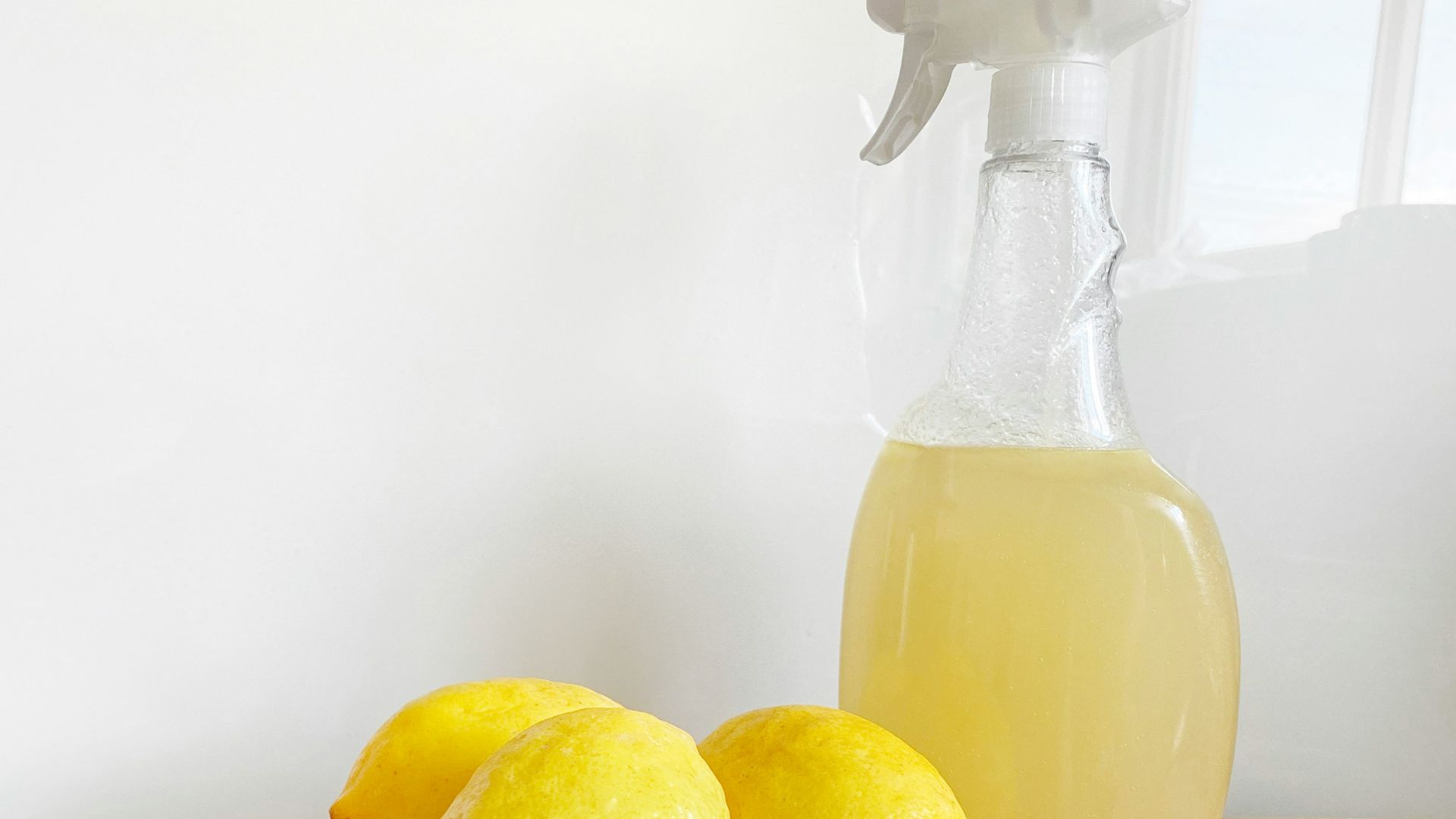 yellow lemon fruit beside clear glass bottle