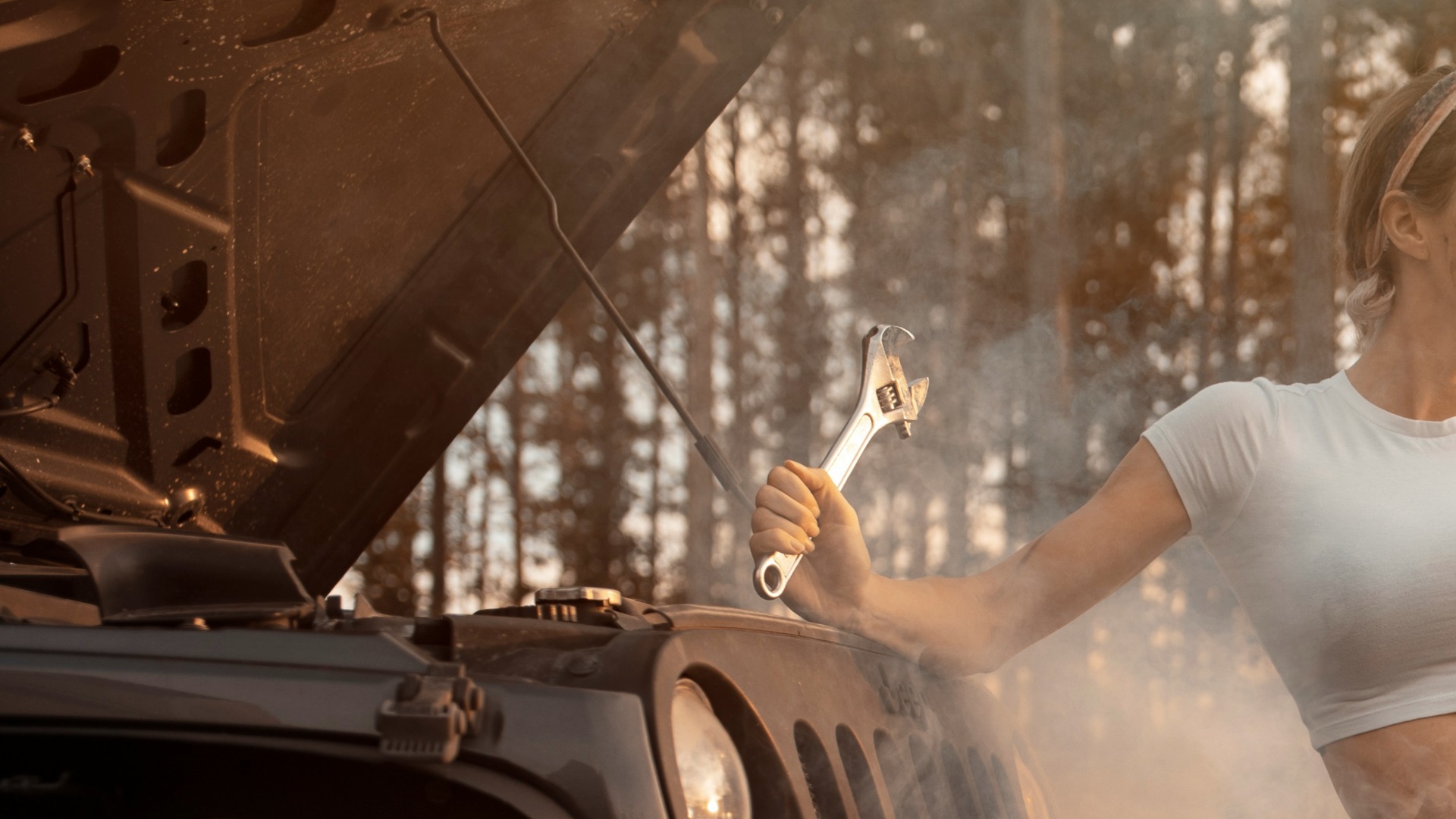 woman in white tank top and blue denim shorts standing on black motorcycle during daytime
