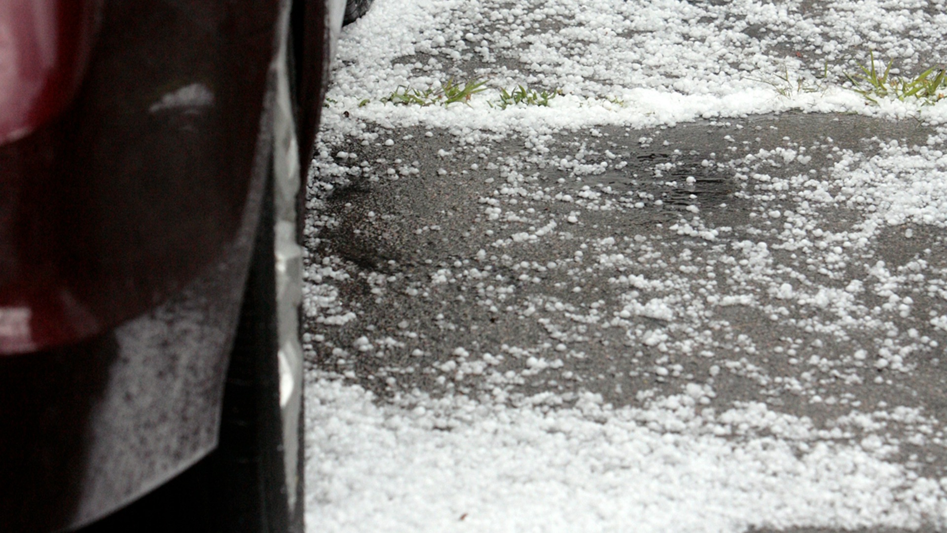 a car on a road with water on the side