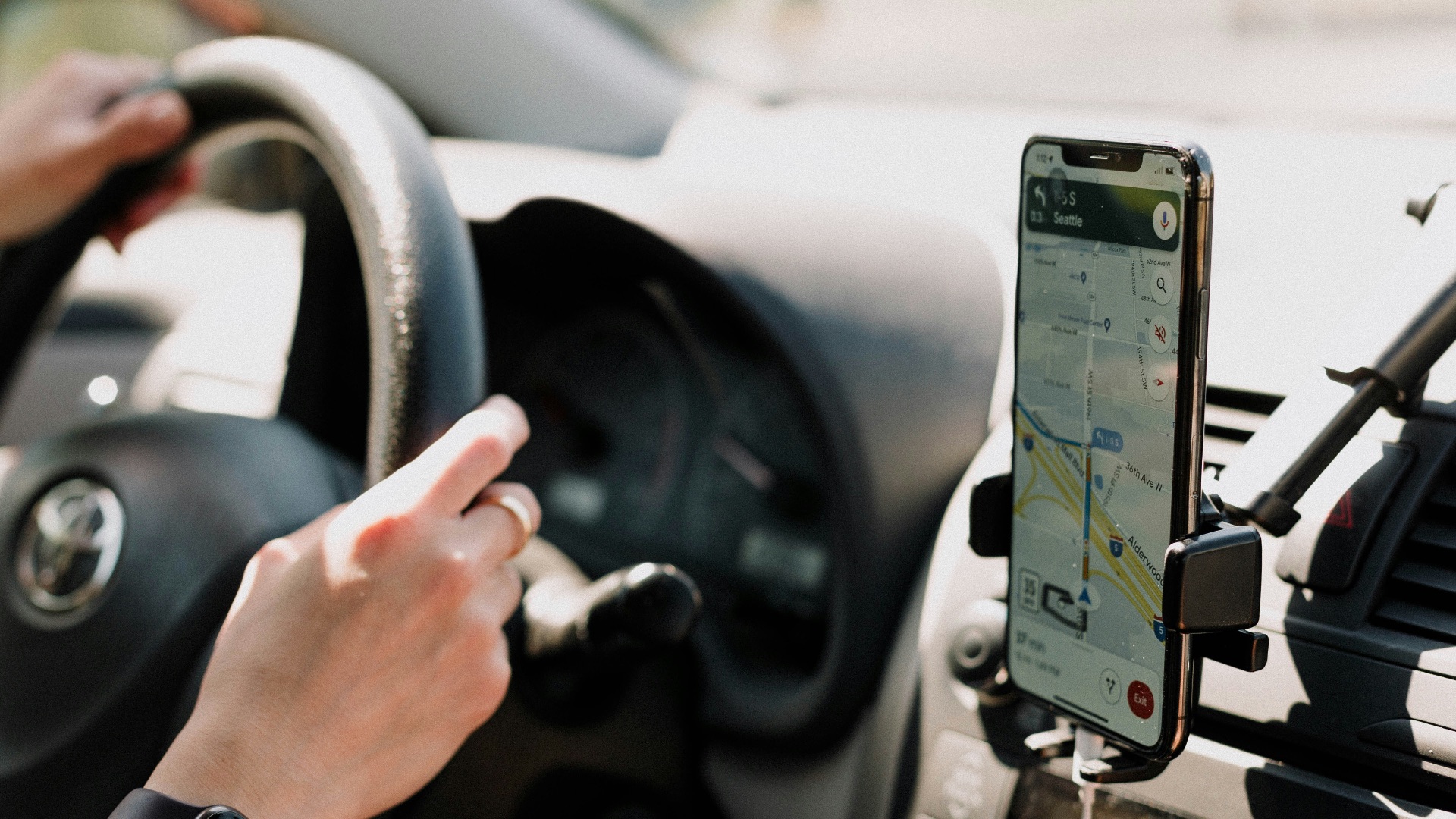 a person using a cell phone while driving a car