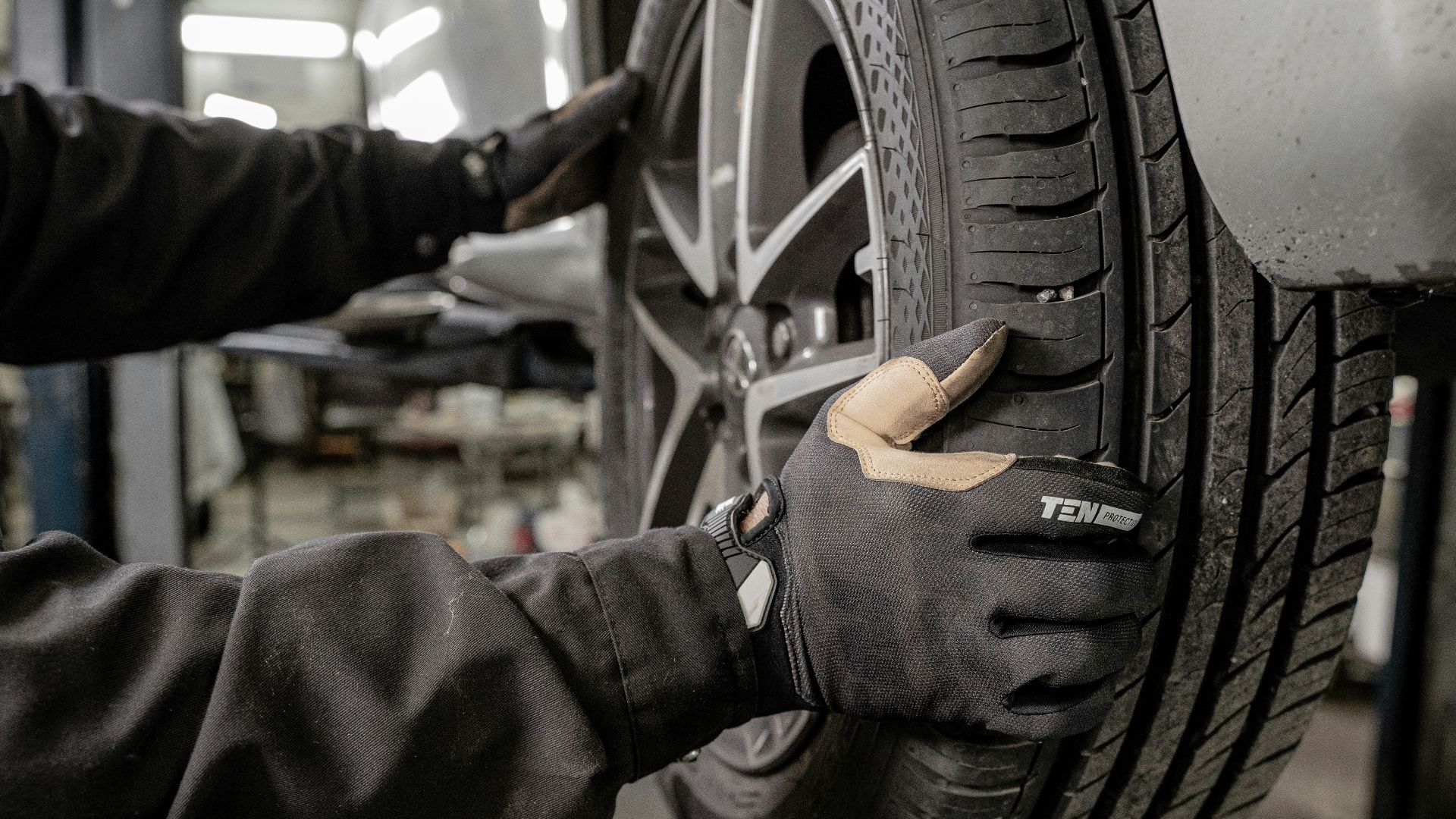 a man working on a tire in a garage