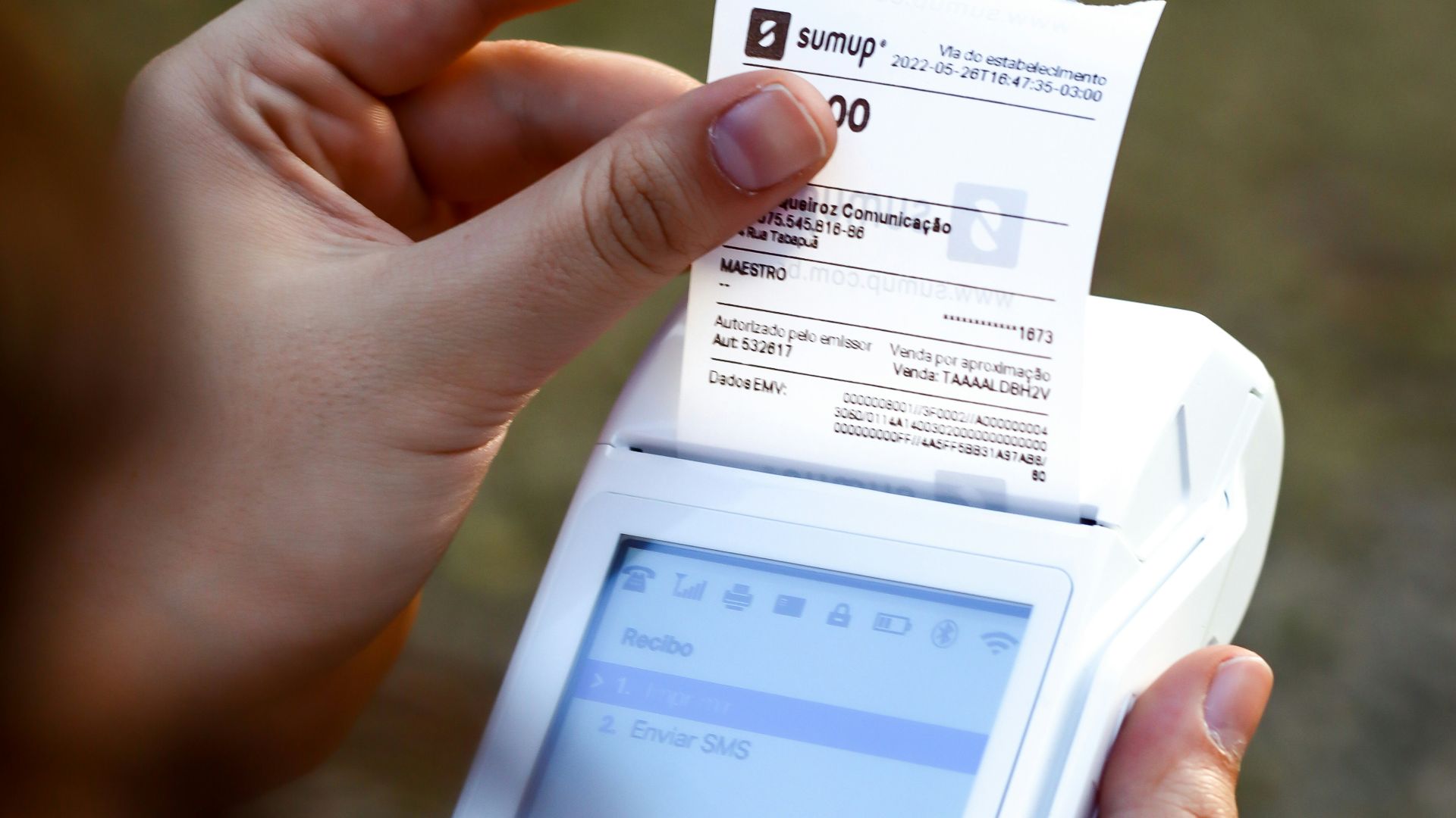 a person holding a cell phone and a receipt