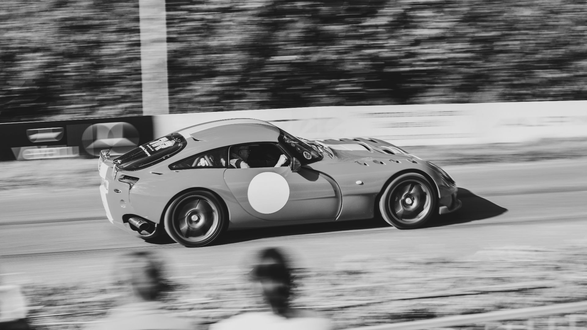 Race car speeding down a track with motion blur